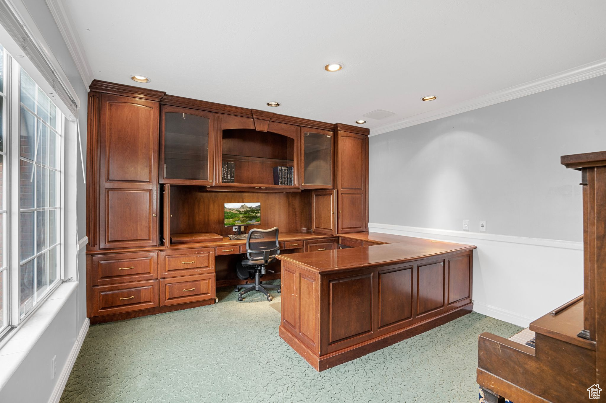 Office area with built in cabinets and crown molding