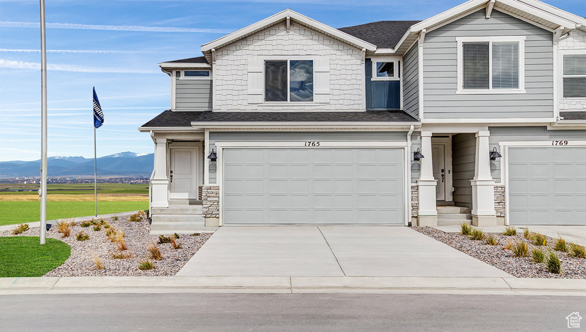 View of front facade featuring a mountain view and a garage