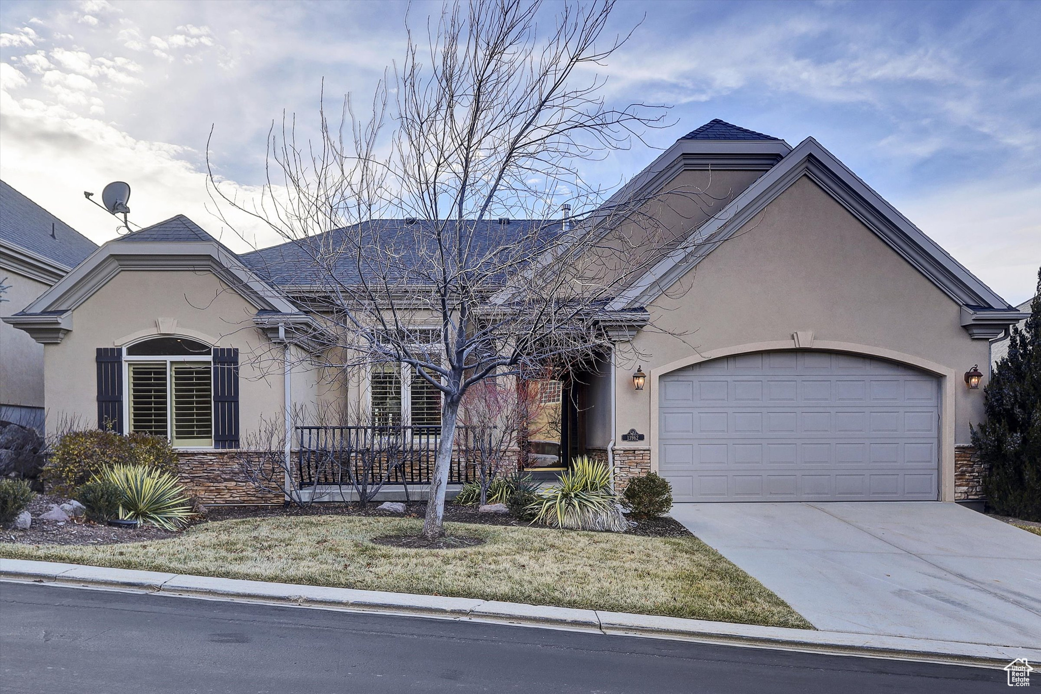 View of front of house featuring a front yard and a garage