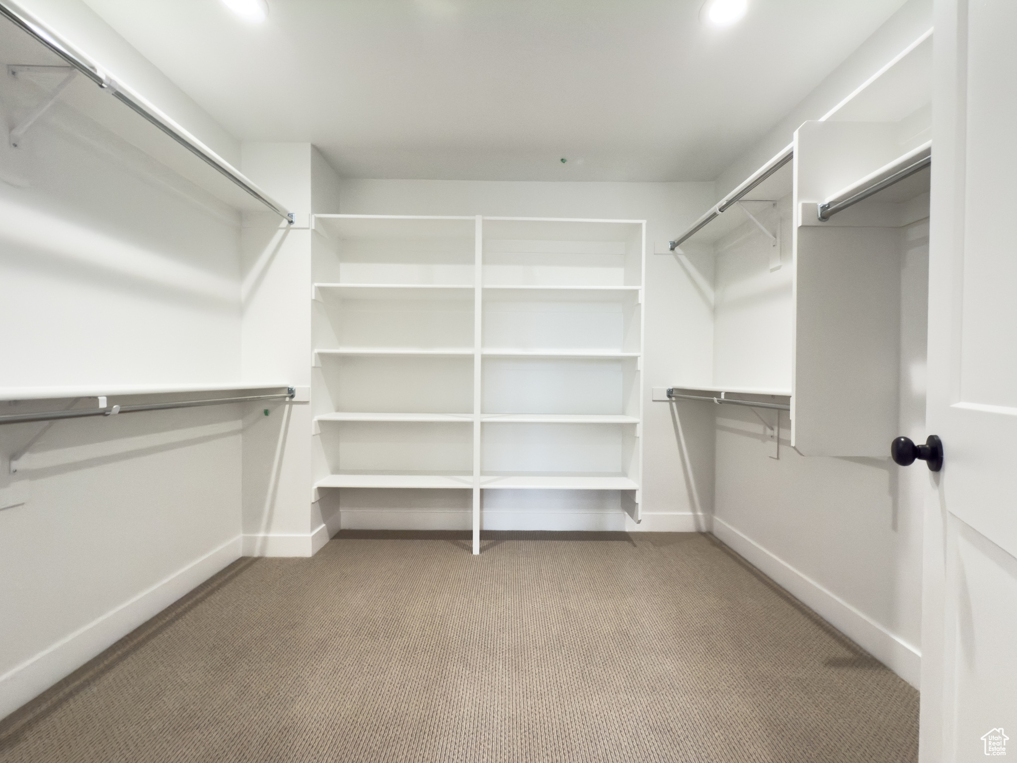 Spacious closet with light colored carpet