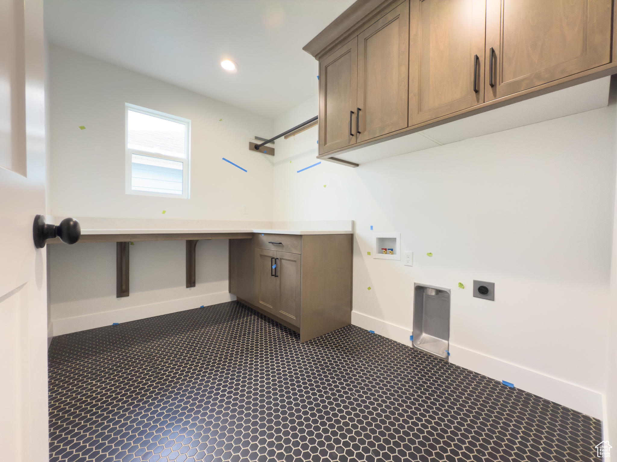 Washroom featuring cabinets, hookup for a washing machine, and electric dryer hookup