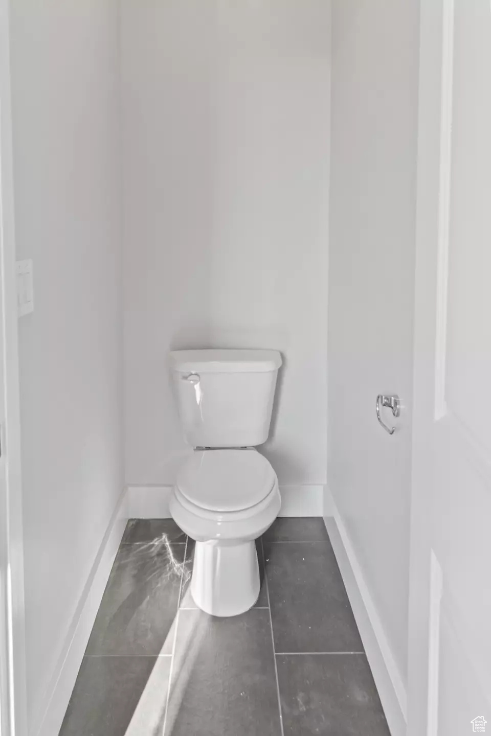 Bathroom featuring tile patterned flooring and toilet