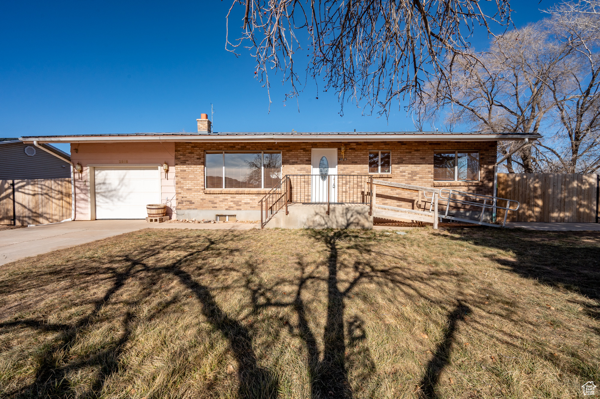 Single story home with a front yard and a garage