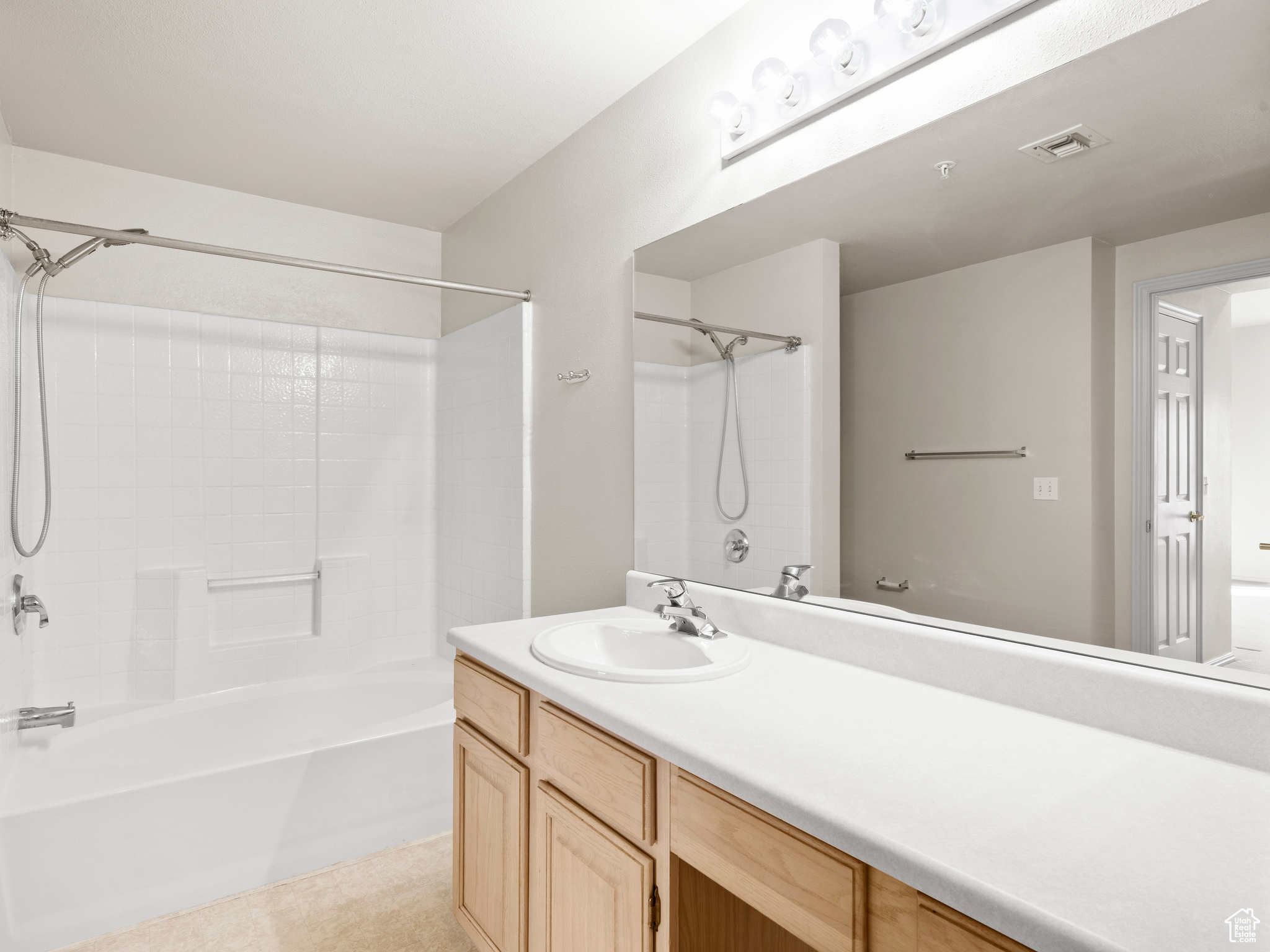 Bathroom featuring vanity and shower / bath combination