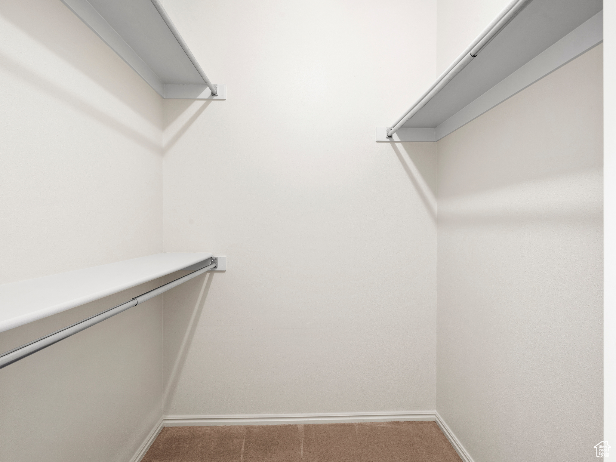 Spacious closet with carpet floors