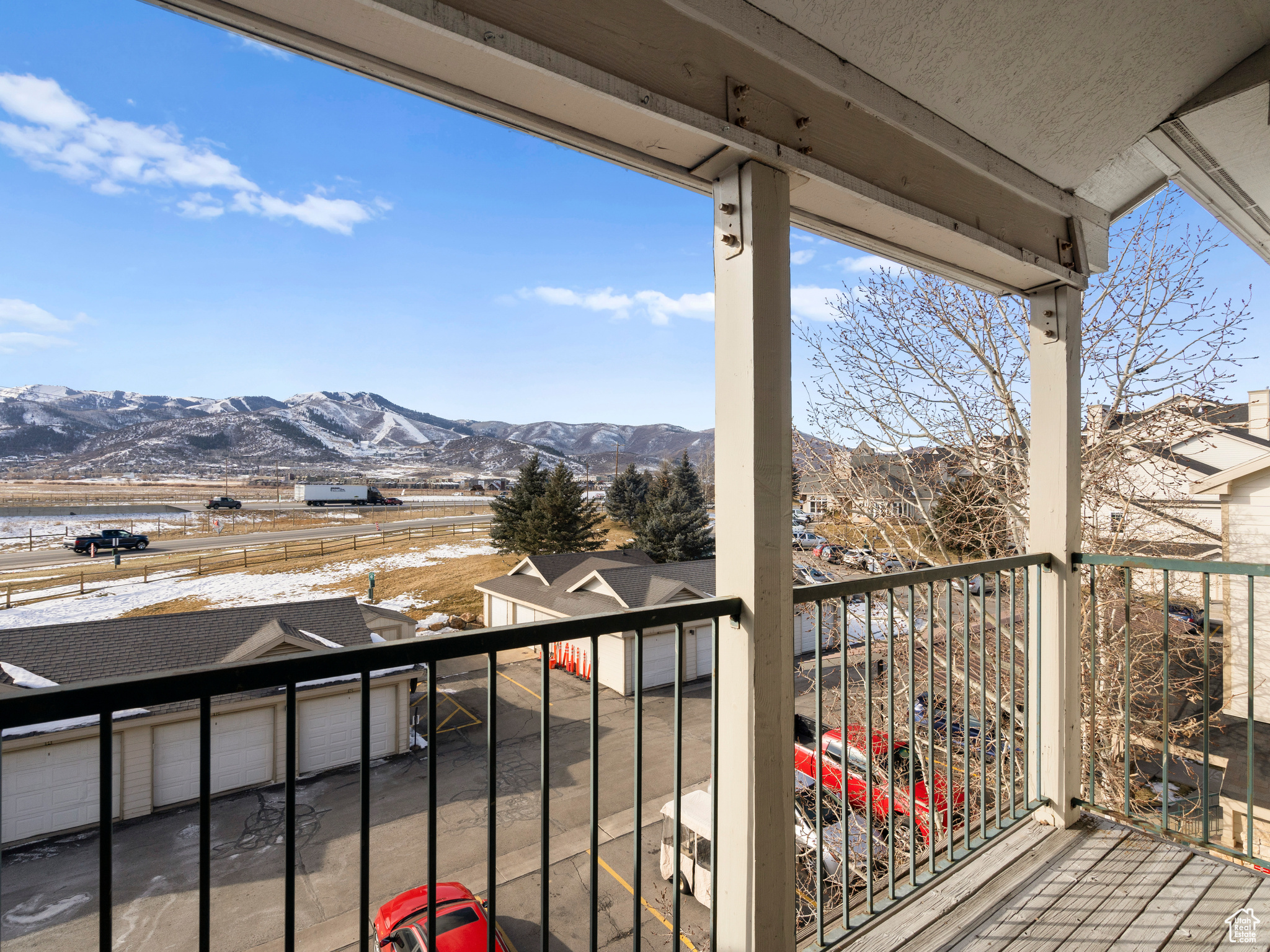 Snow covered back of property featuring a mountain view