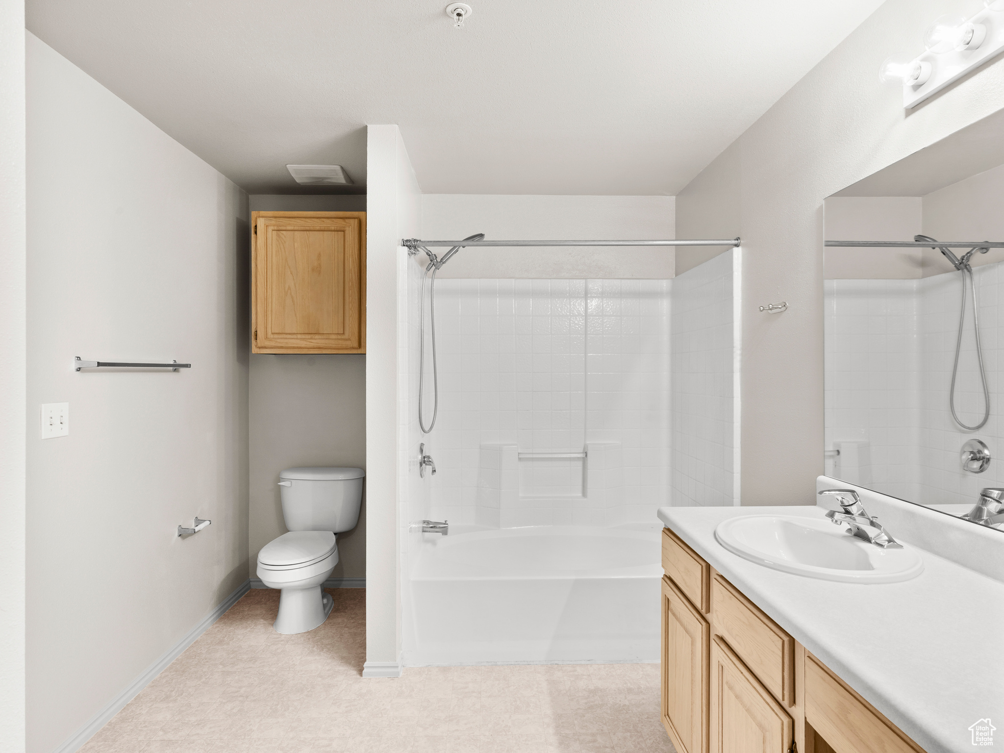 Full bathroom featuring shower / tub combination, vanity, and toilet