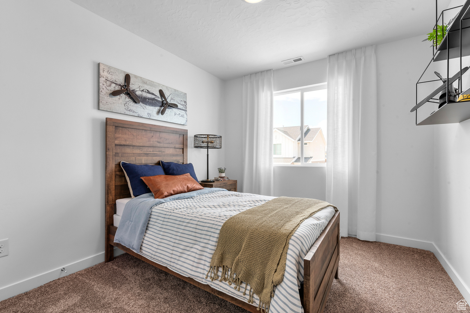 Bedroom with carpet and a textured ceiling