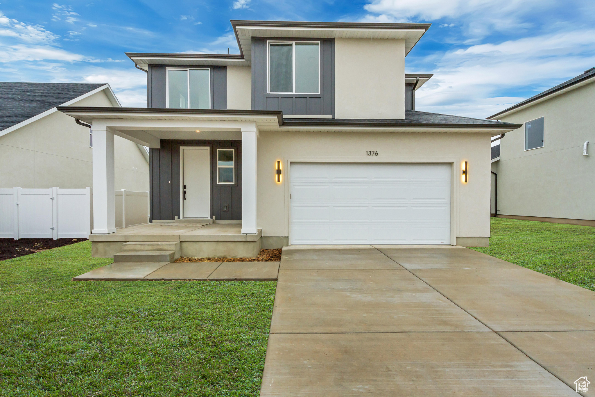 View of front facade featuring a front lawn and a garage