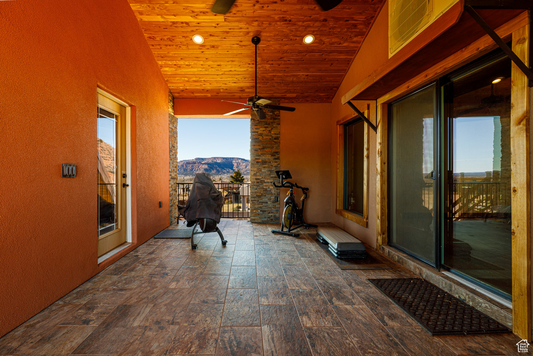 View of patio / terrace with a mountain view, a balcony, and ceiling fan