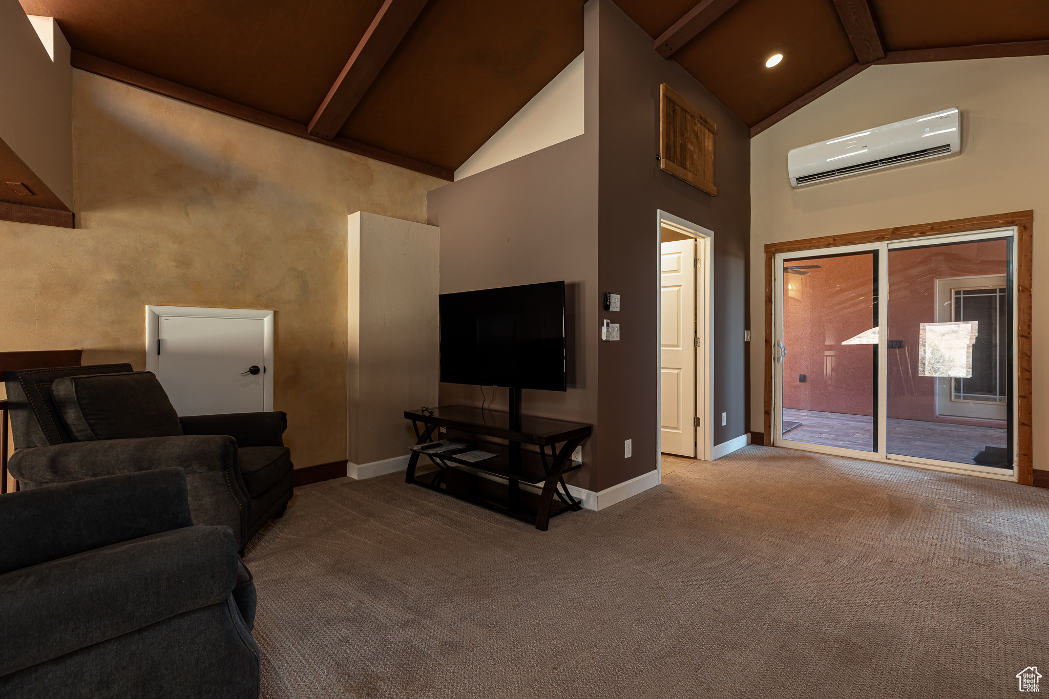 Family Room with a wall unit AC, beamed ceiling, and high vaulted ceiling