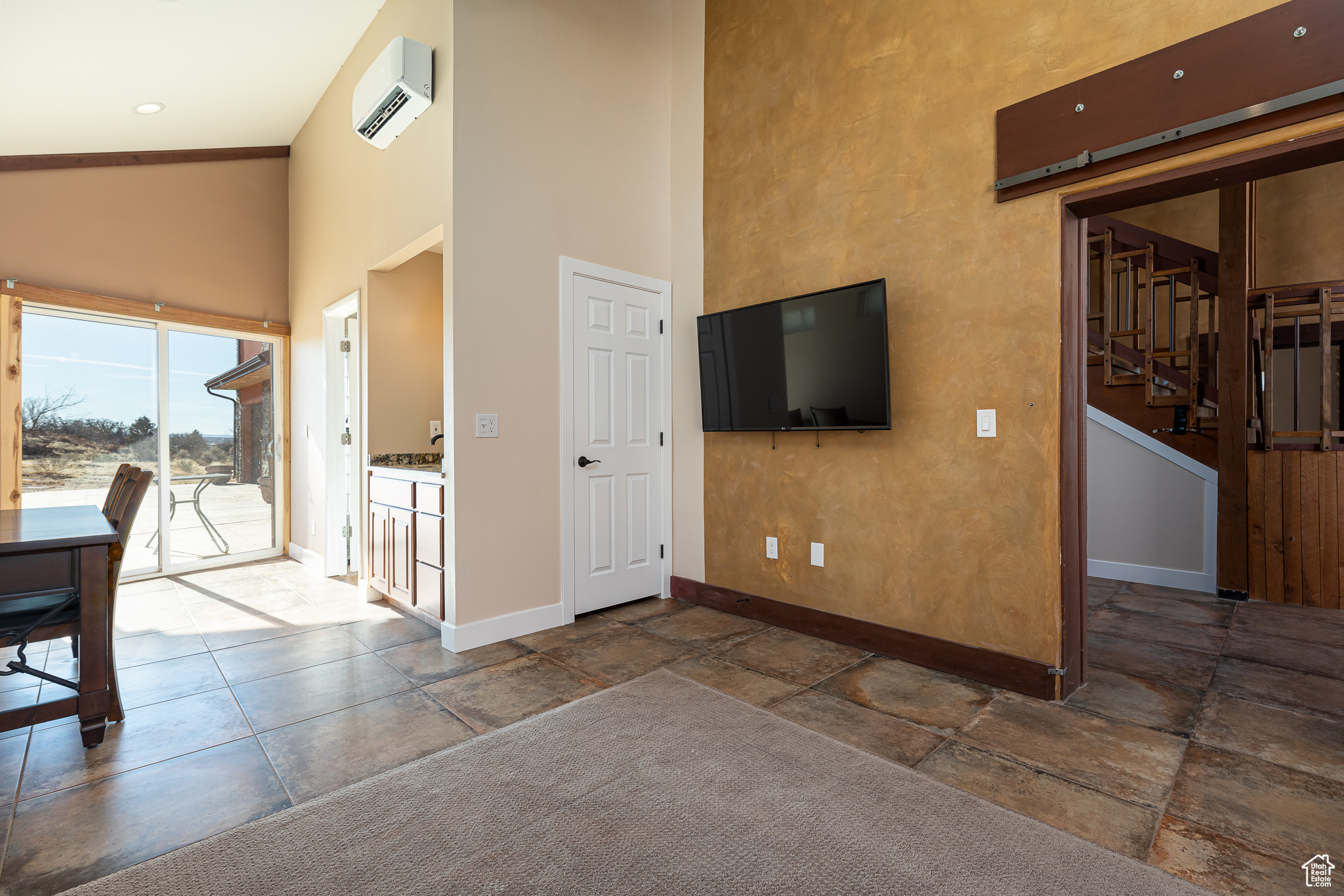 Master bedroom #2 featuring a high ceiling and a wall mounted AC