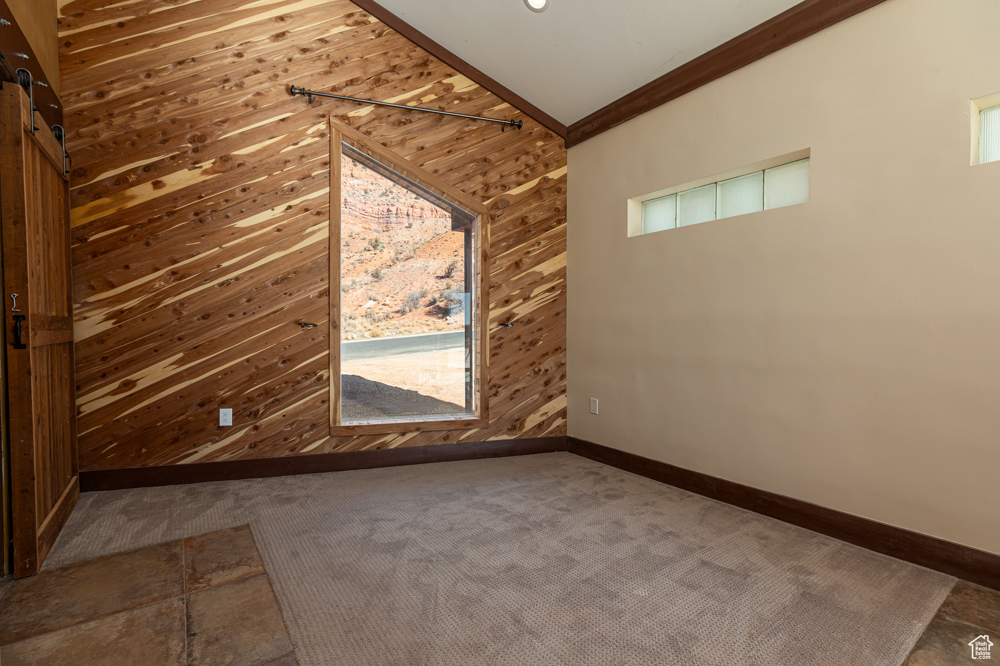 Master bedroom #2 high vaulted ceiling carpet flooring, plenty of natural light, lofted ceiling, and wooden walls