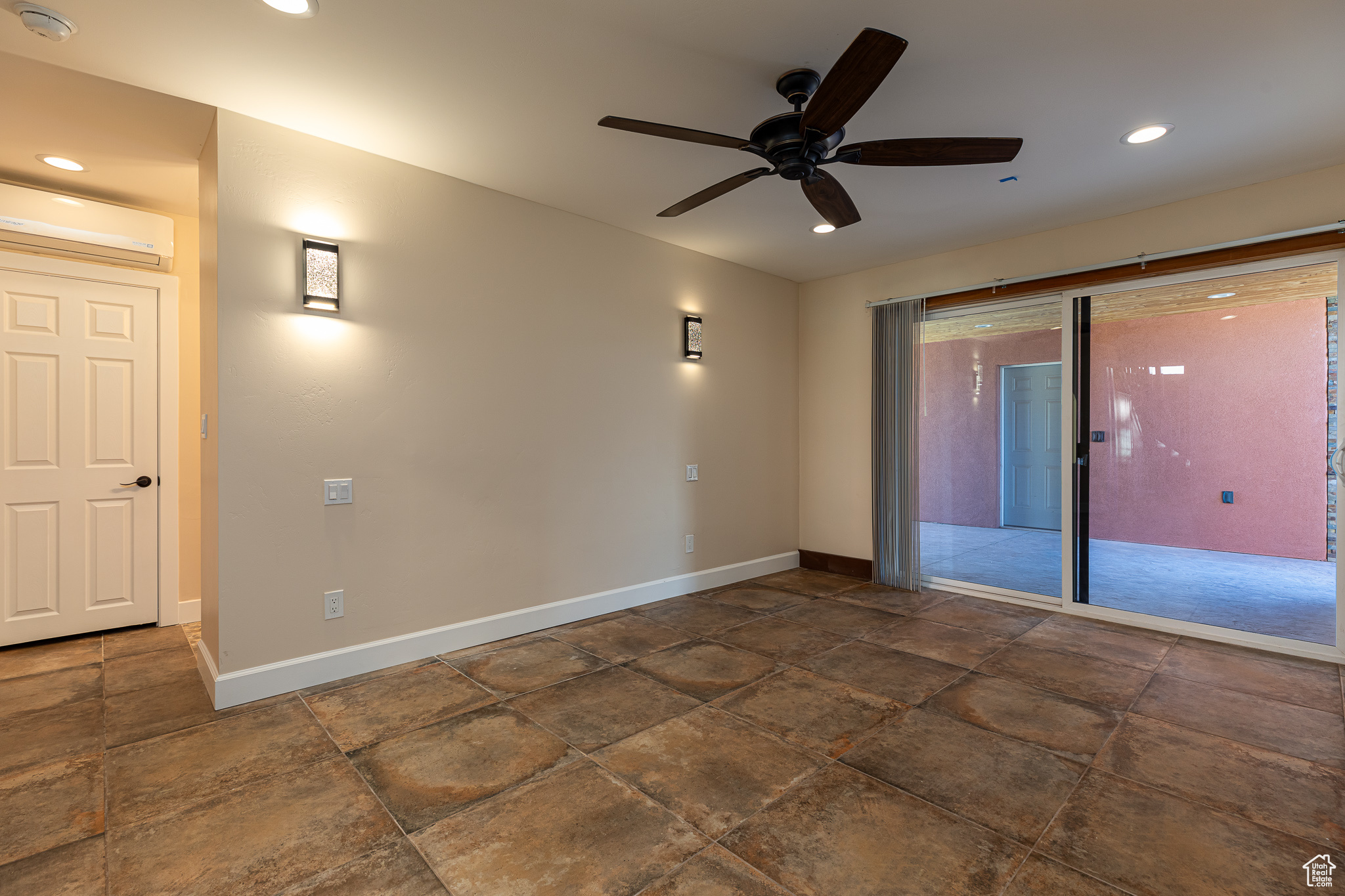 Master bedroom #1 featuring an AC wall unit and ceiling fan