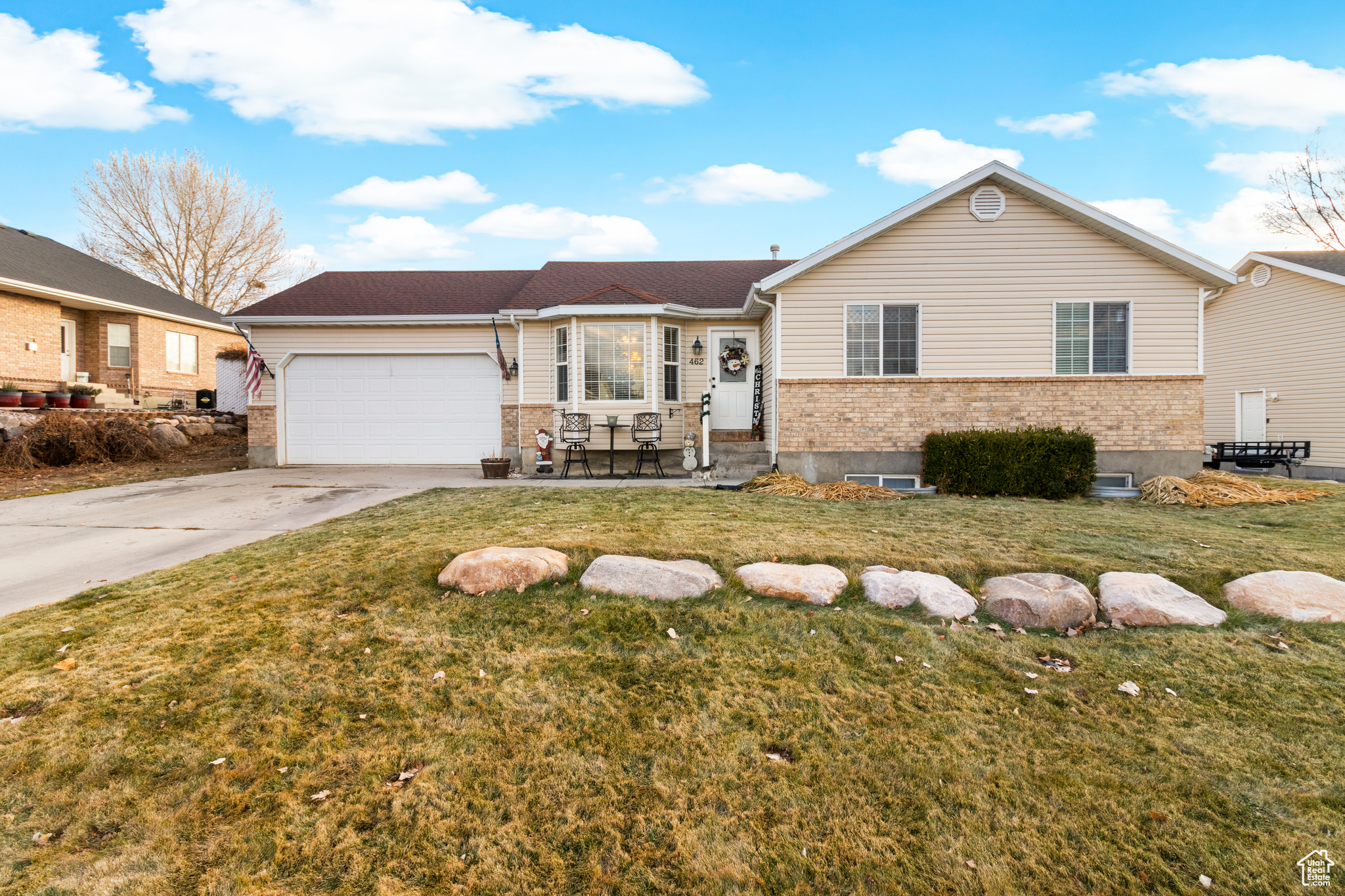 View of front of house featuring a garage and a front lawn