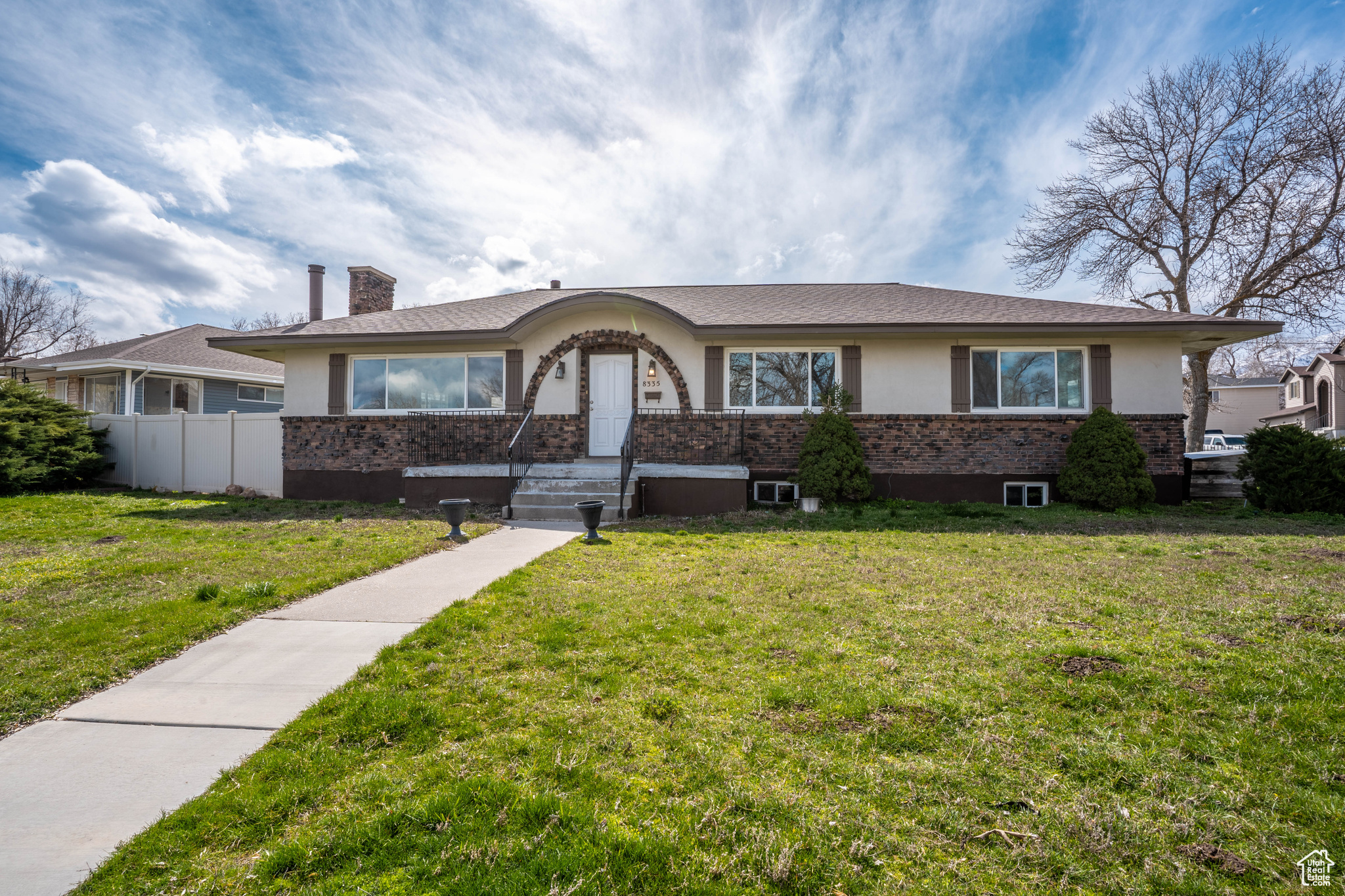 Single story home with a front lawn