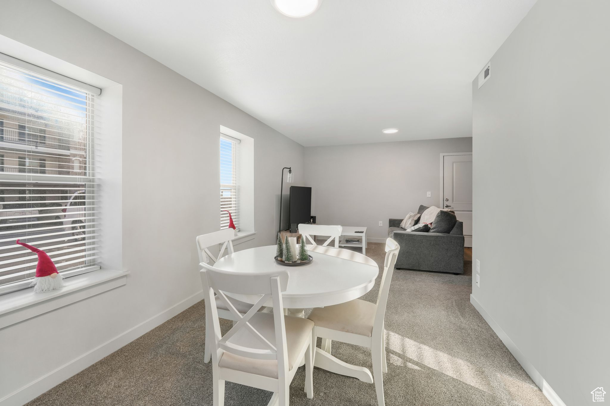 Dining room with carpet floors and a wealth of natural light