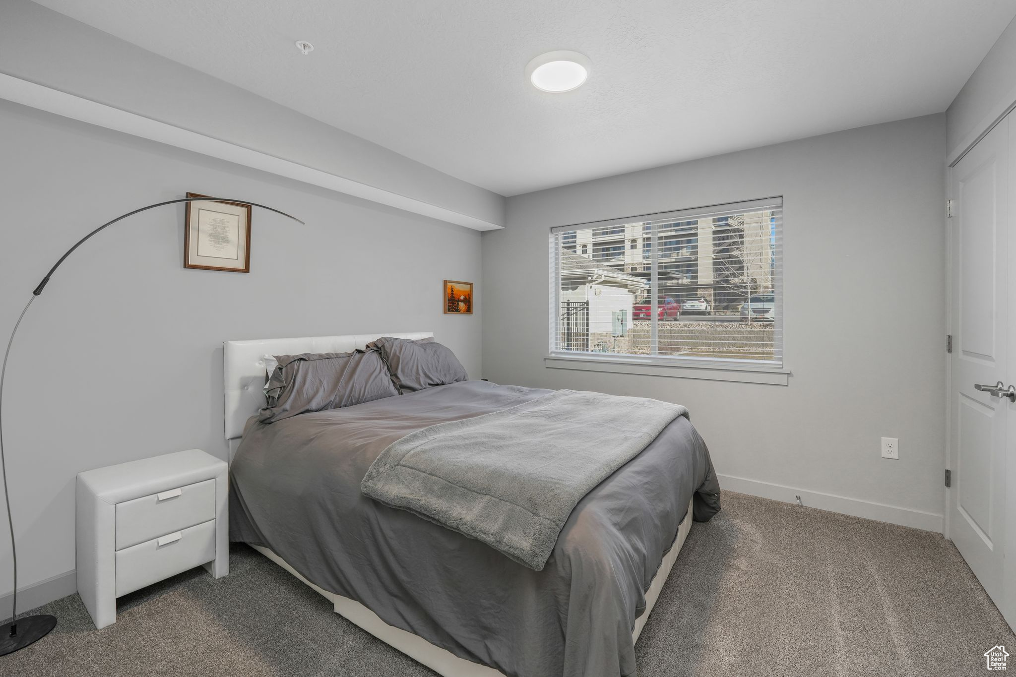 Bedroom with dark colored carpet