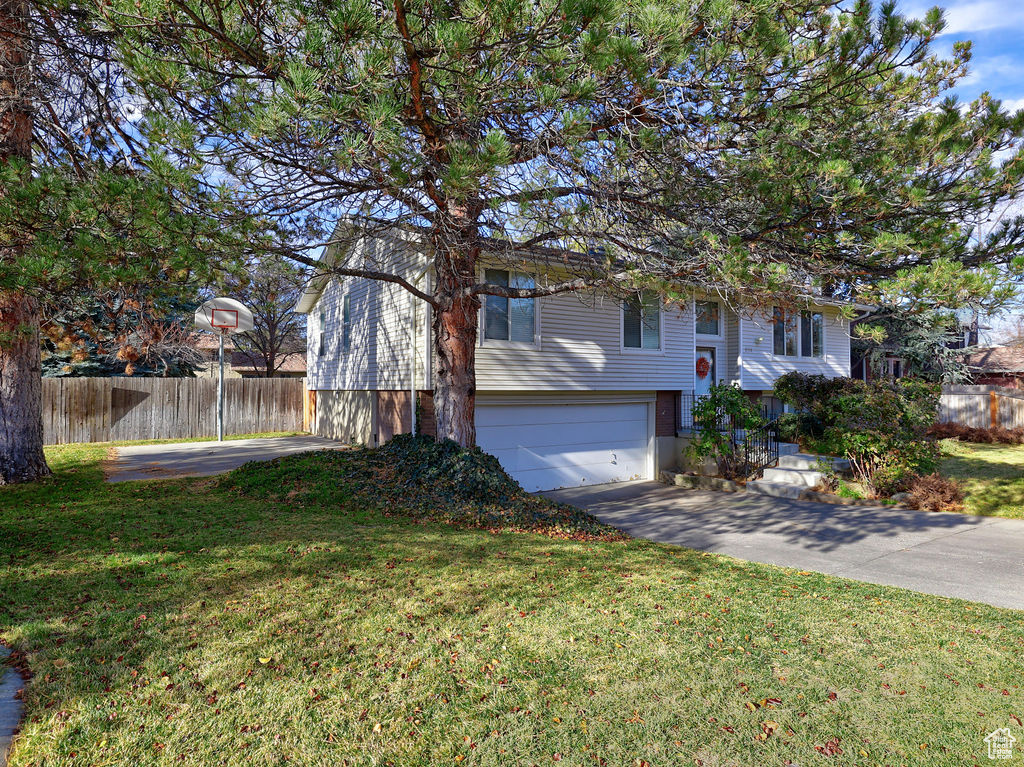 View of front of house with a front lawn and a garage