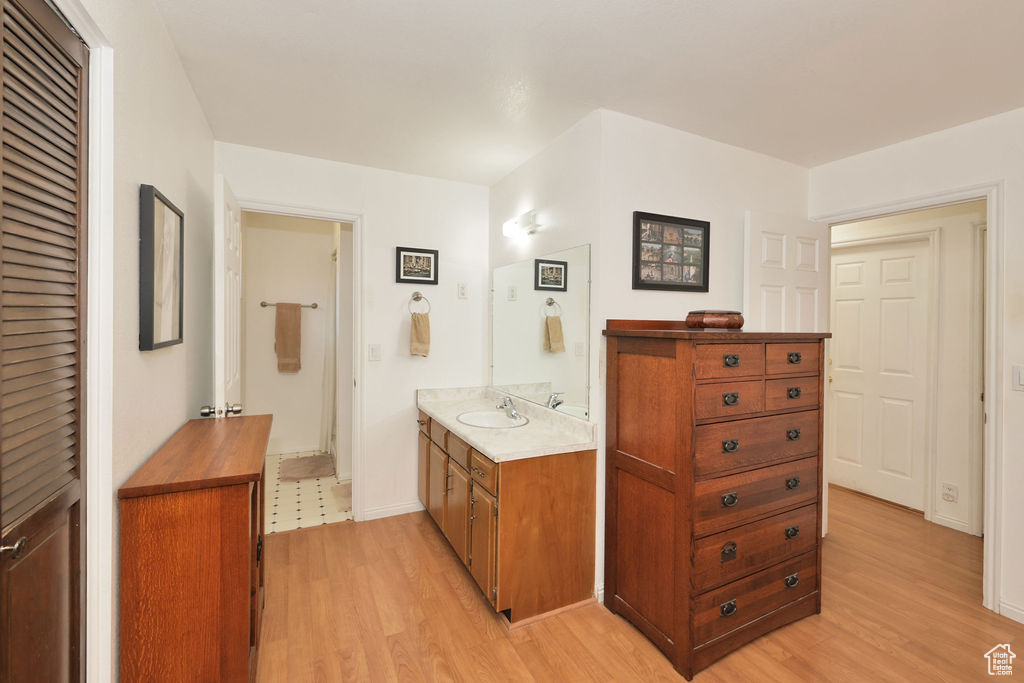 Bathroom with hardwood / wood-style floors and vanity