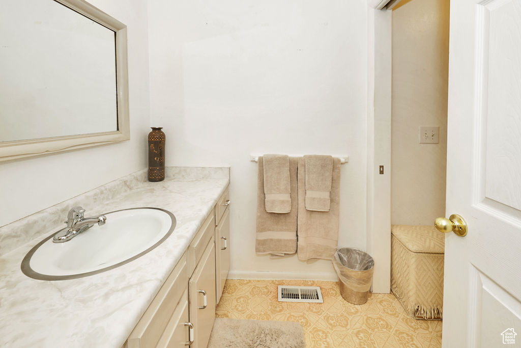 Bathroom featuring tile patterned flooring and vanity