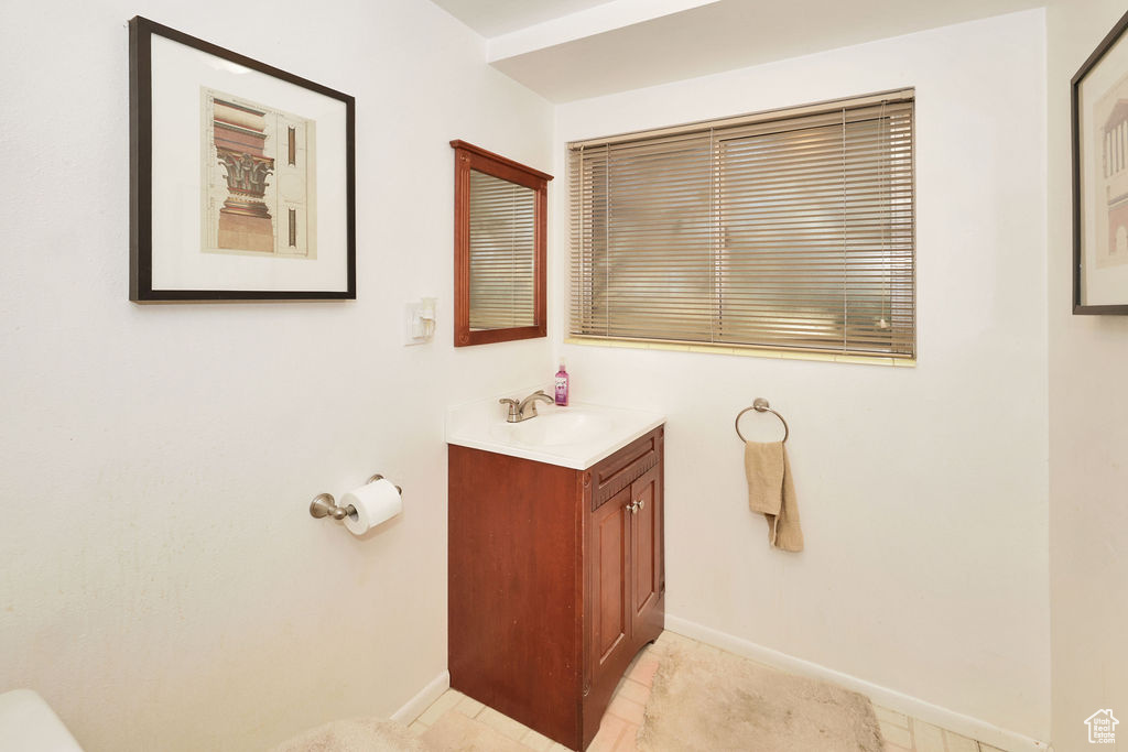 Bathroom featuring tile patterned floors and vanity