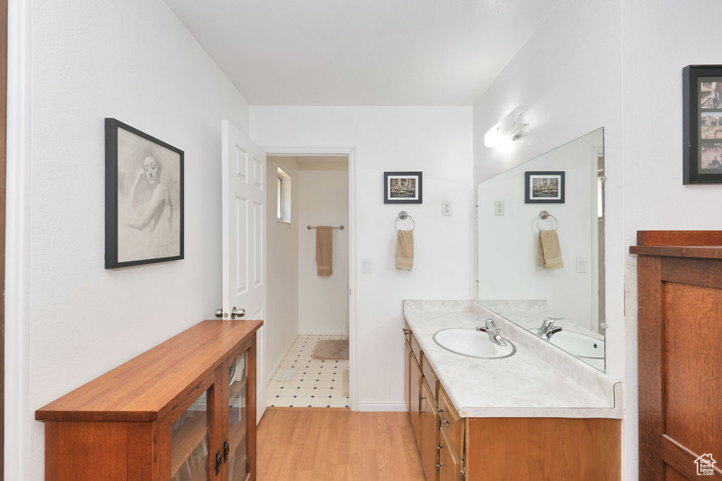 Bathroom with hardwood / wood-style floors and vanity