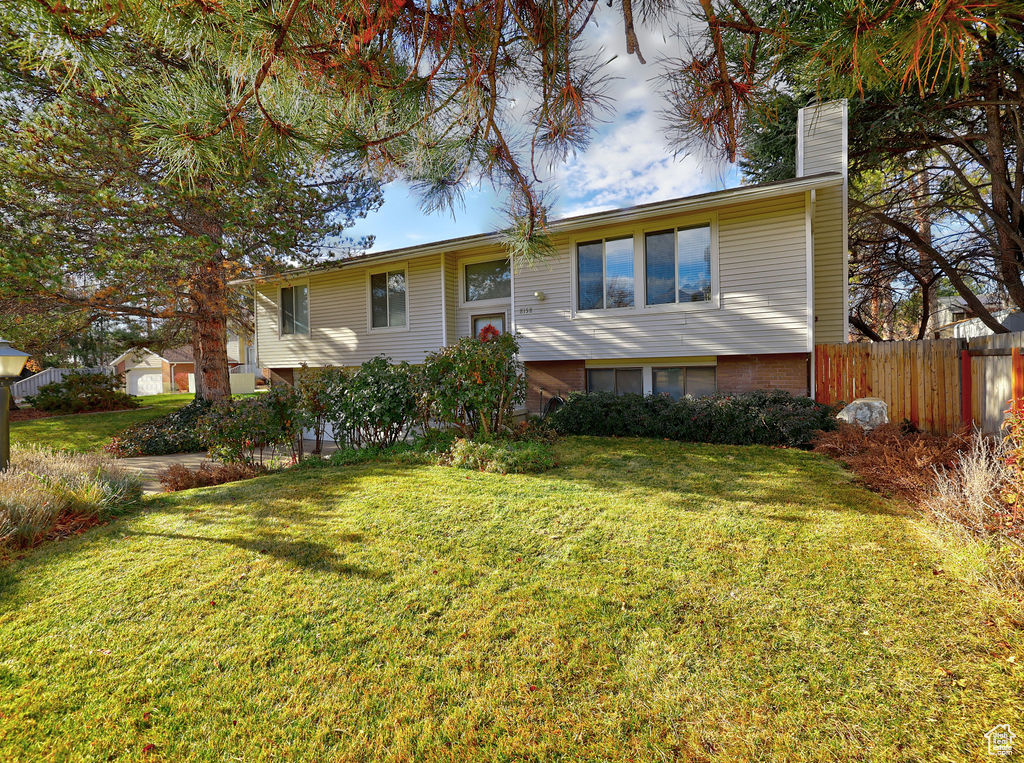 Bi-level home featuring a front lawn