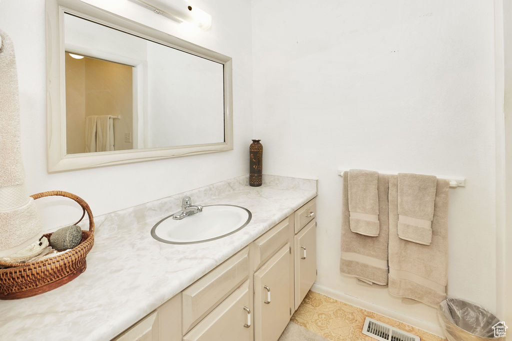 Bathroom featuring tile patterned floors and vanity