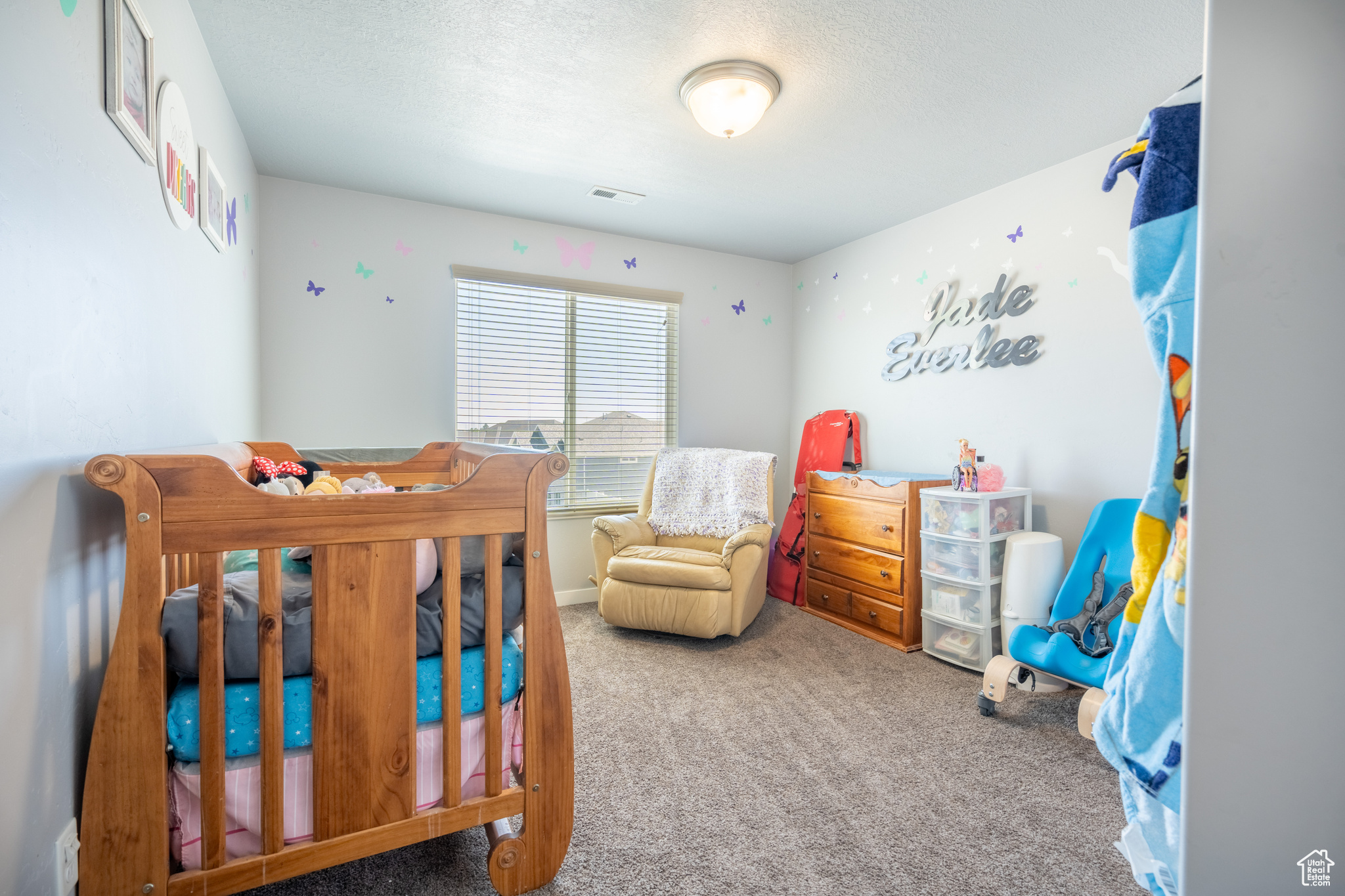 Bedroom featuring a textured ceiling and carpet floors