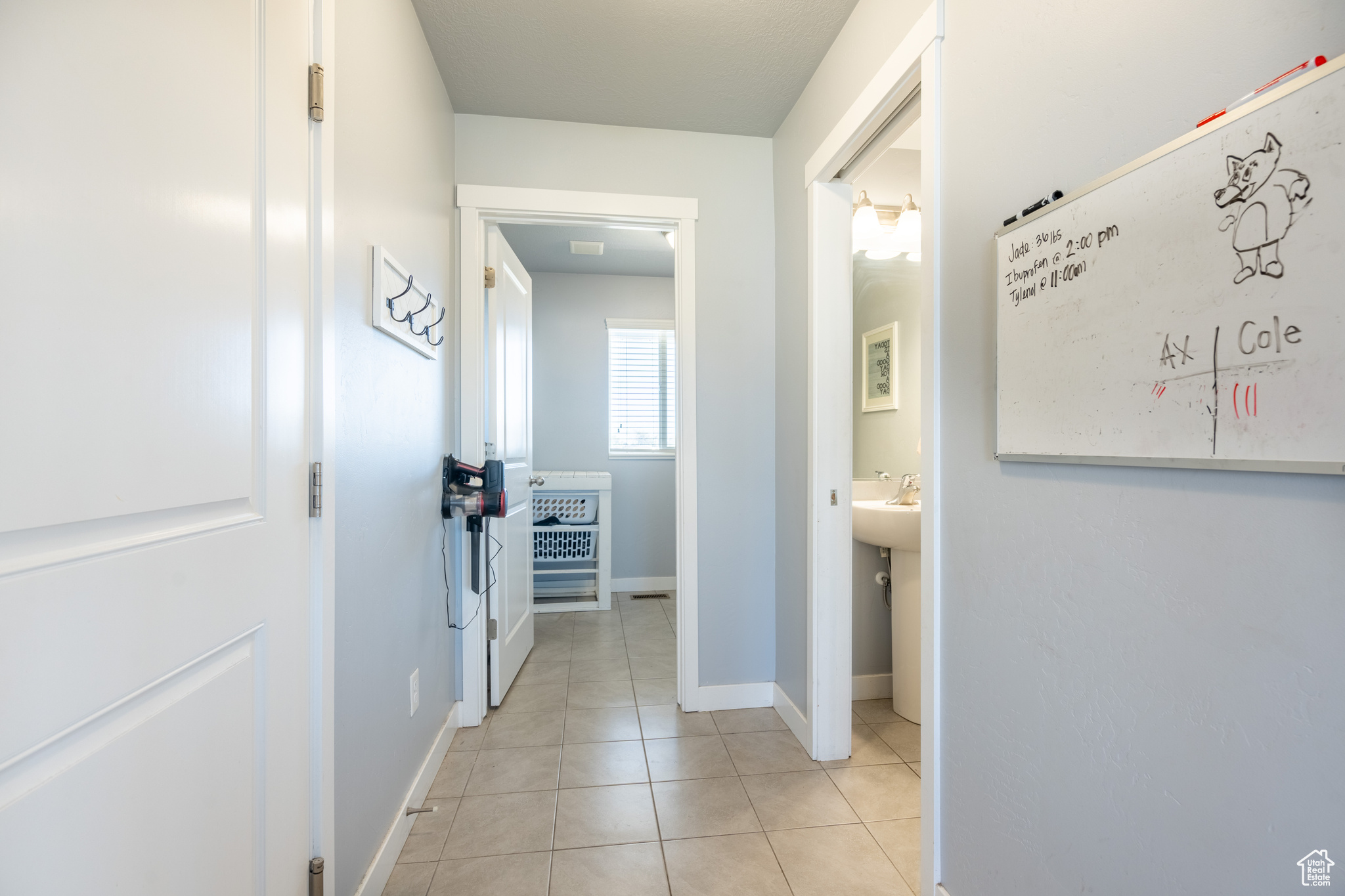 Hallway with light tile patterned floors