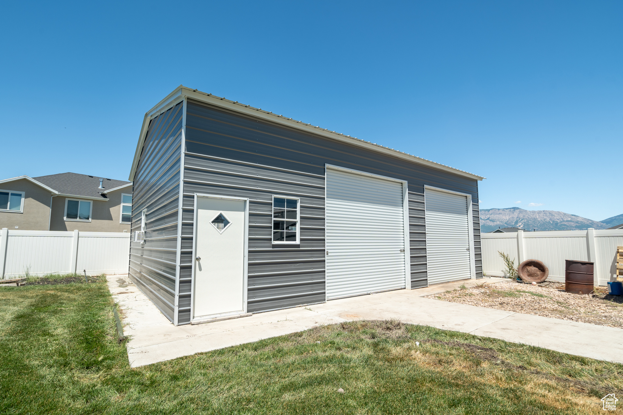 Garage featuring a lawn and a mountain view