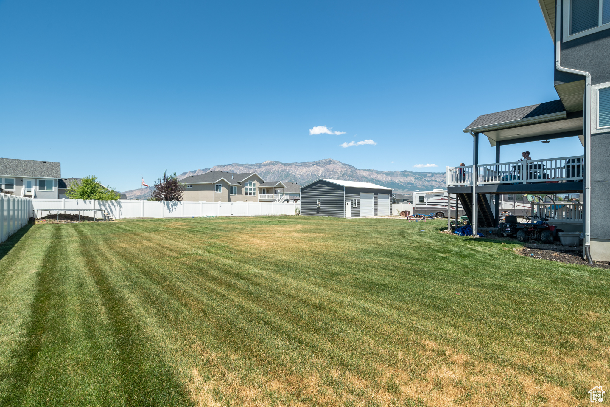 View of yard with a deck with mountain view