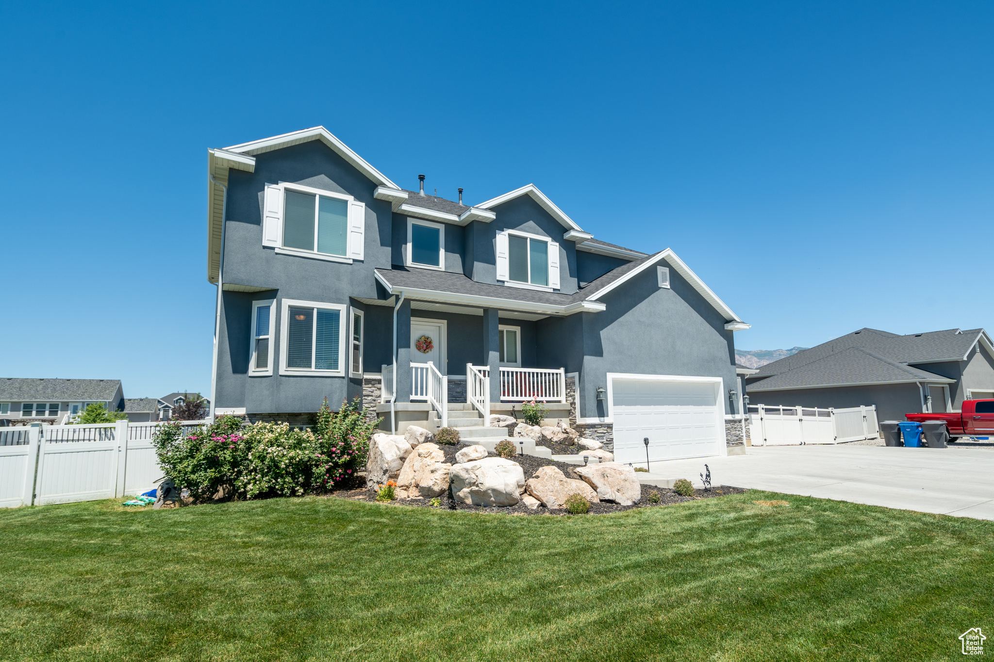 Craftsman-style home with covered porch and a front yard