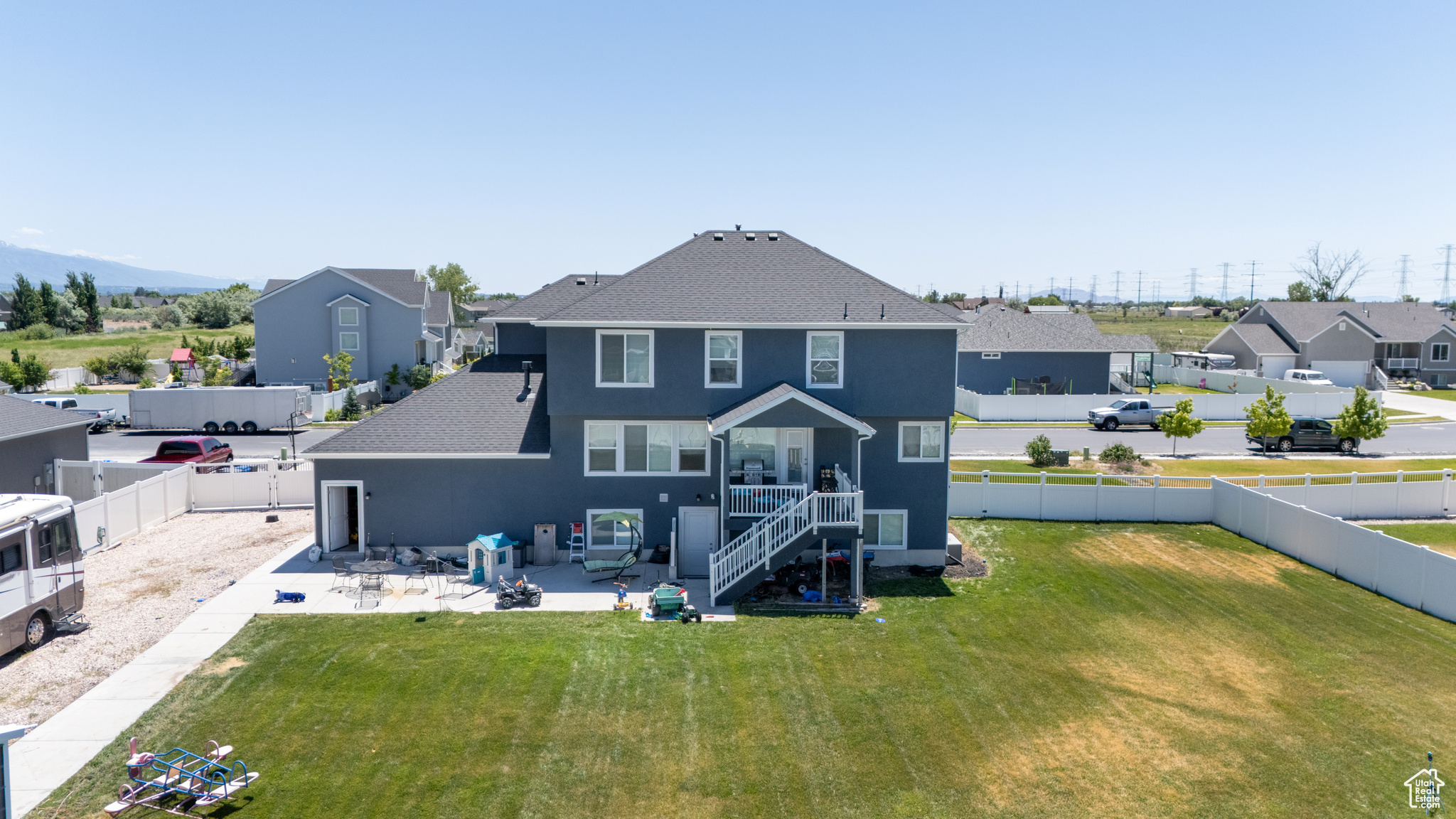 Rear view of house featuring a patio area and a yard