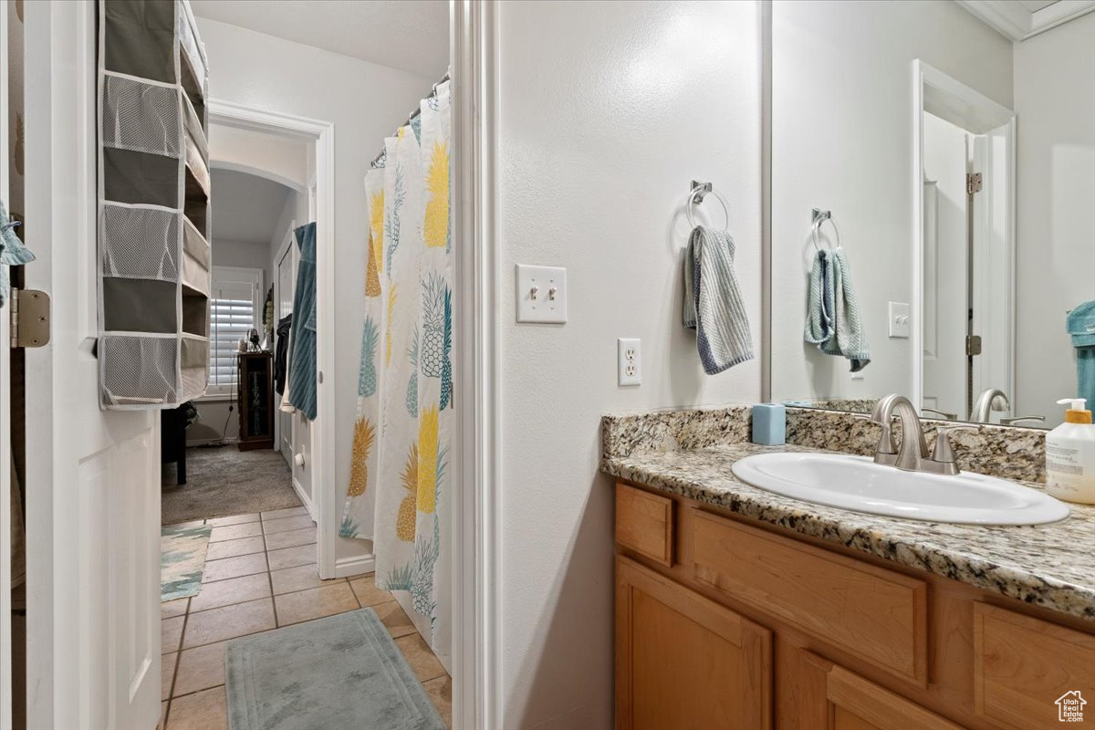 Bathroom featuring tile patterned flooring and vanity