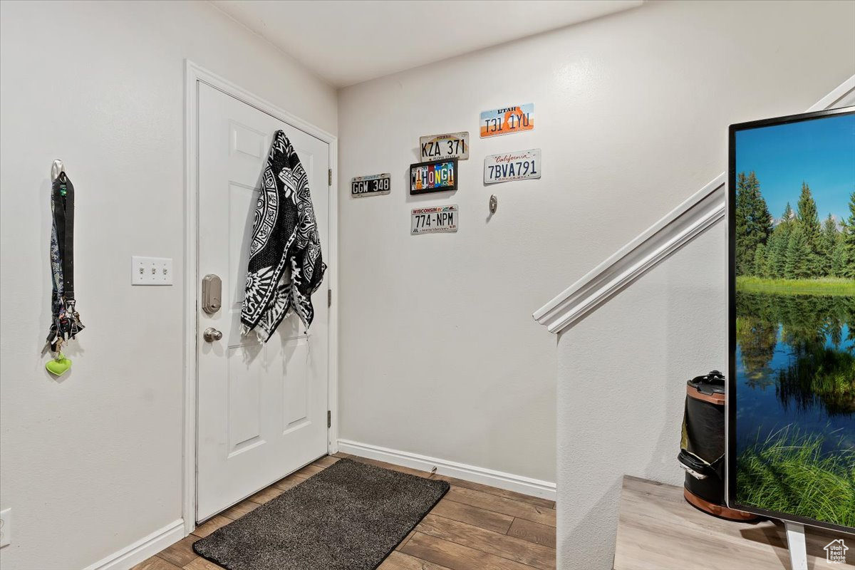 Entrance foyer with light wood-type flooring