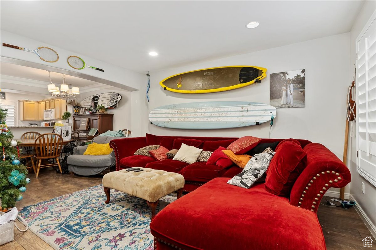 Living room featuring a notable chandelier and dark hardwood / wood-style flooring