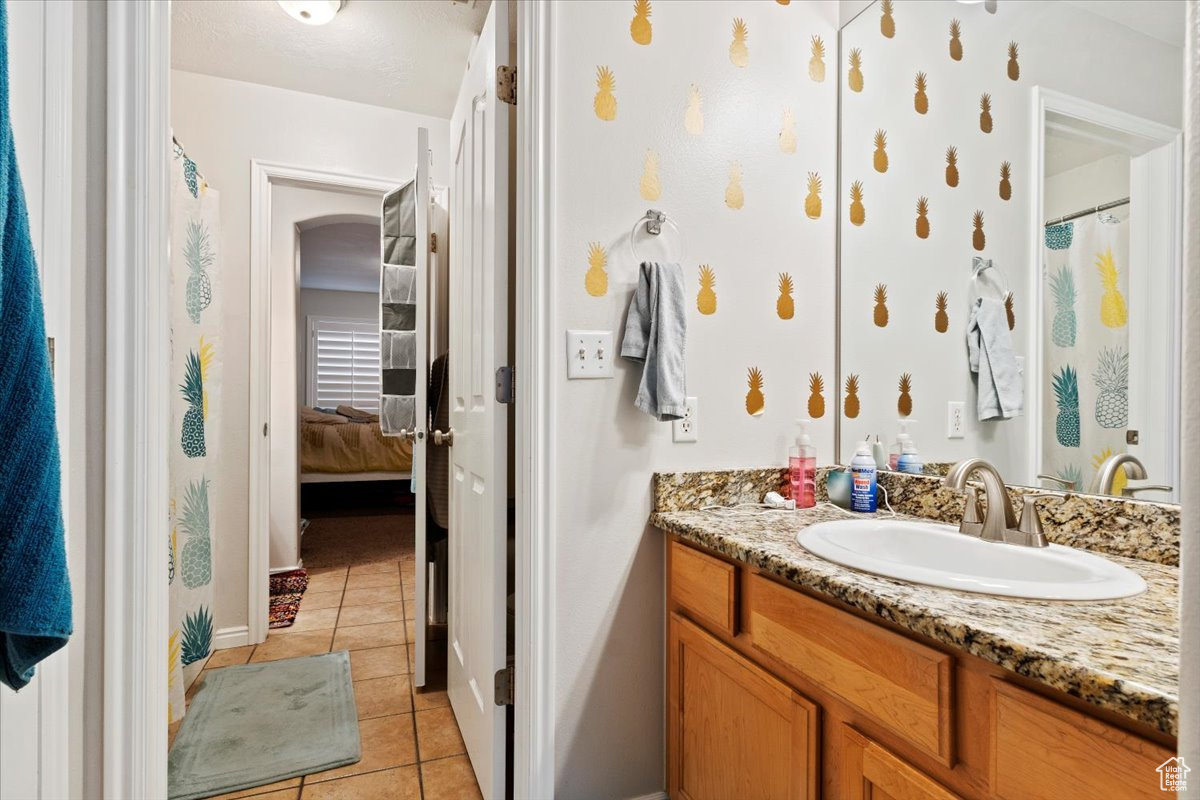 Bathroom with tile patterned floors and vanity