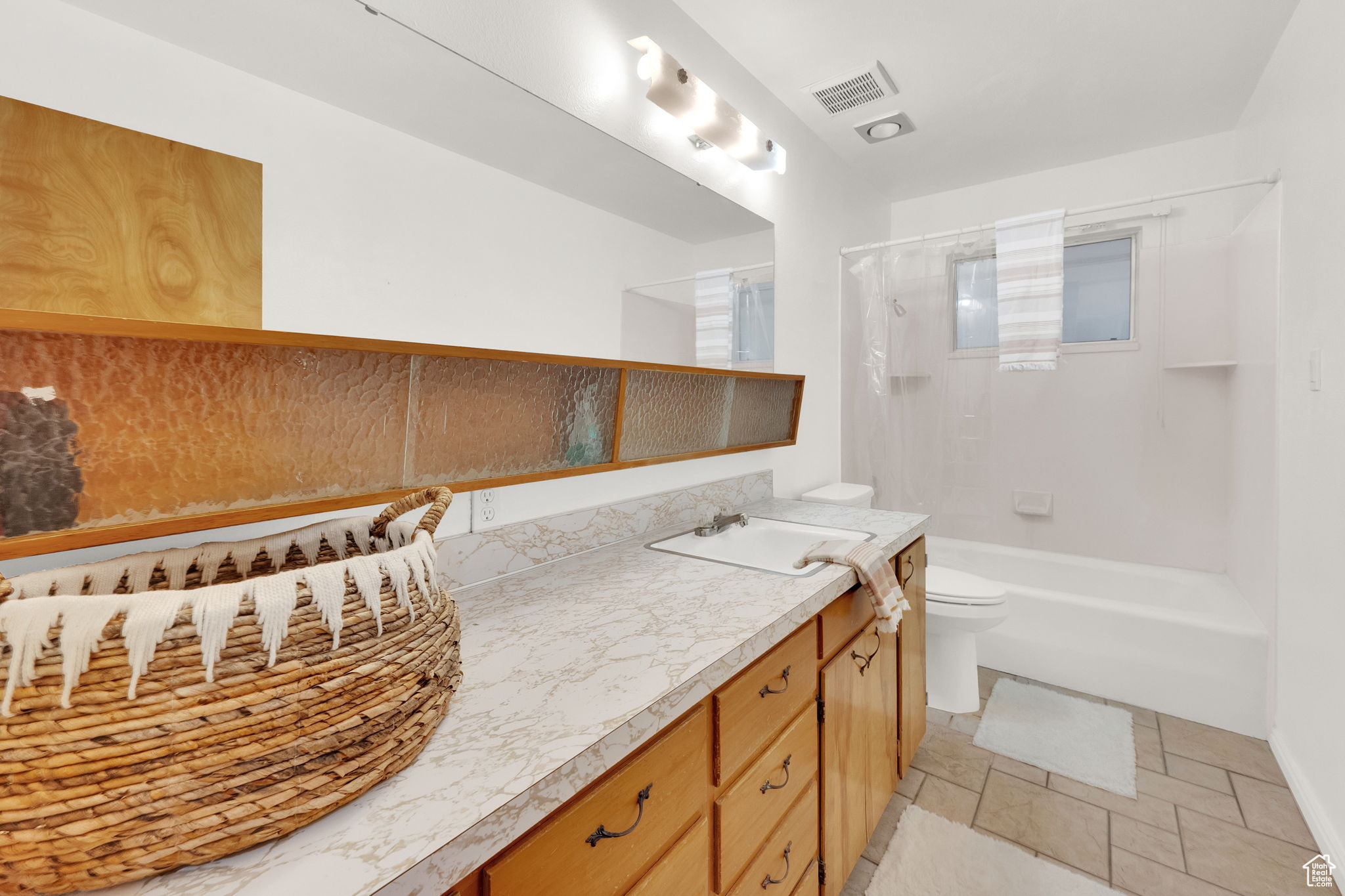 Full bathroom with vanity, shower / bathtub combination, and toilet