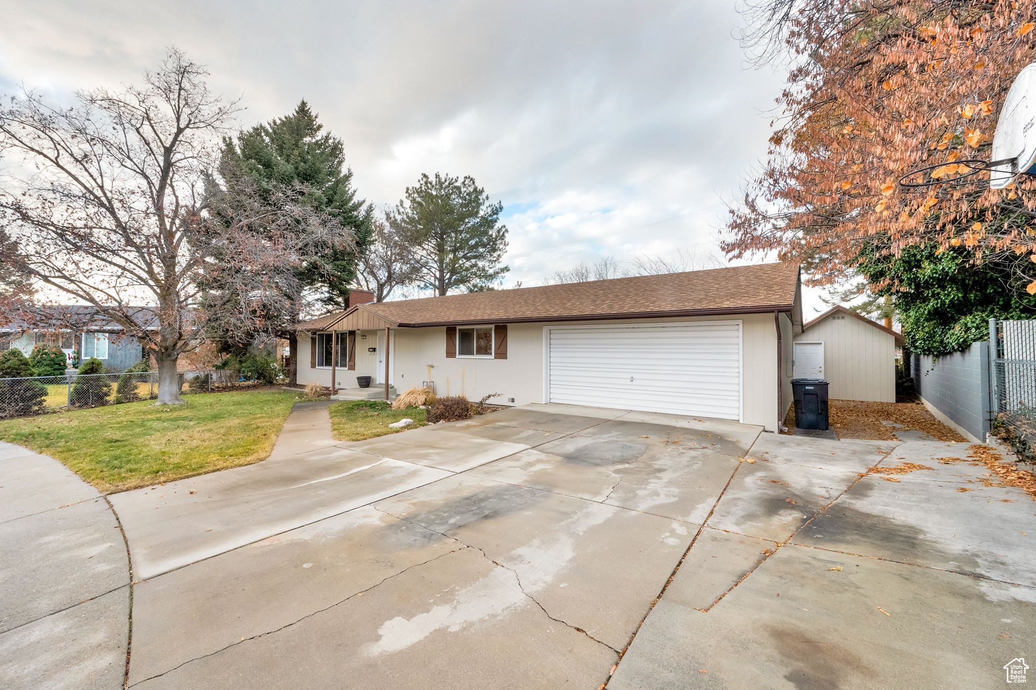 Ranch-style home featuring a garage and a front yard