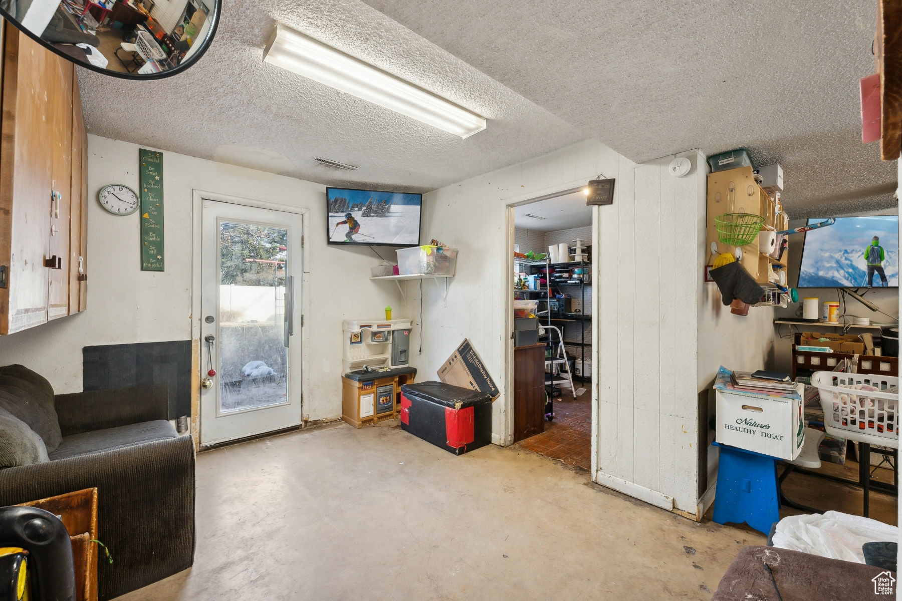 Interior space featuring concrete flooring and a textured ceiling