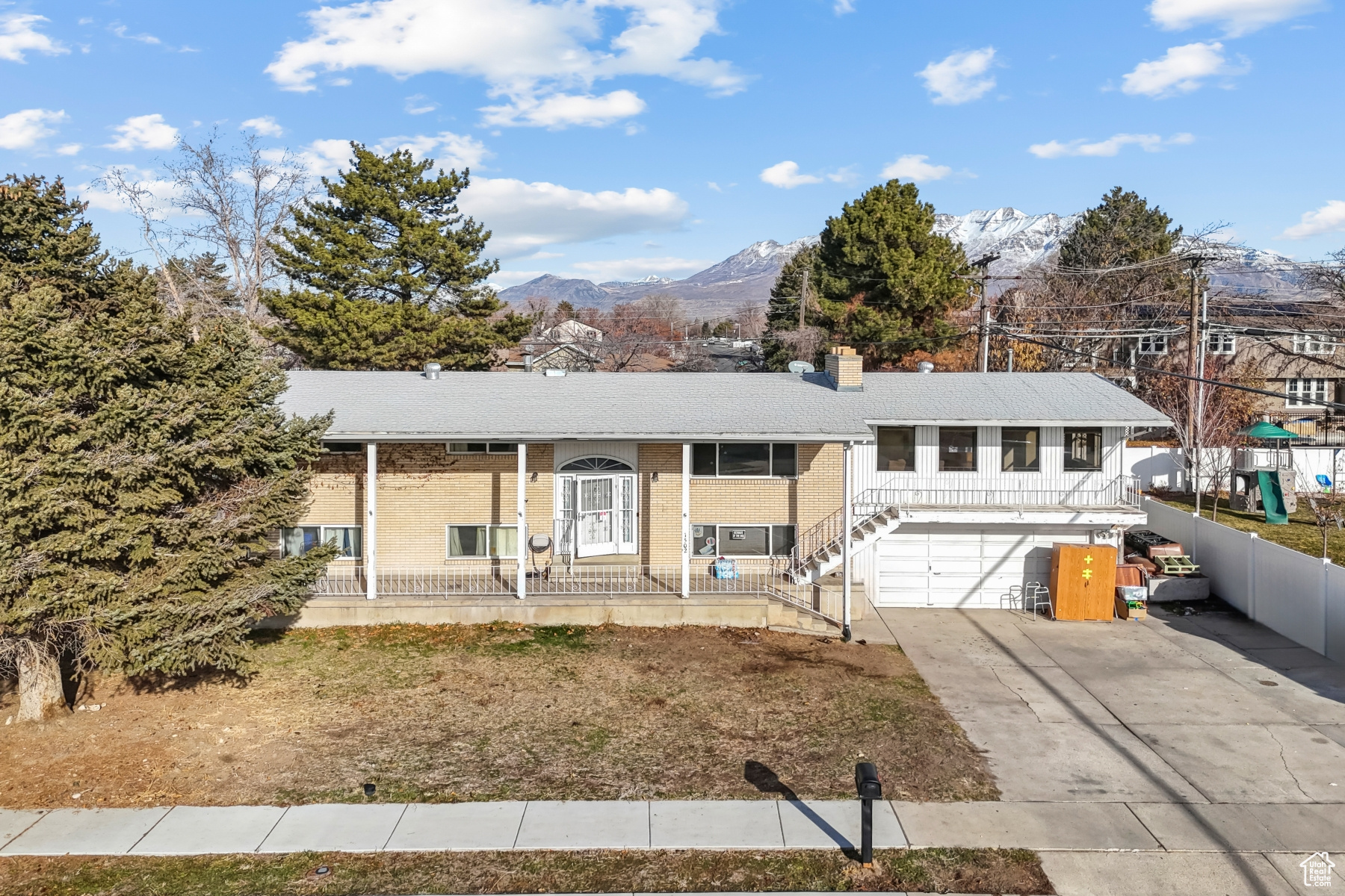 View of front of property with a mountain view and a garage