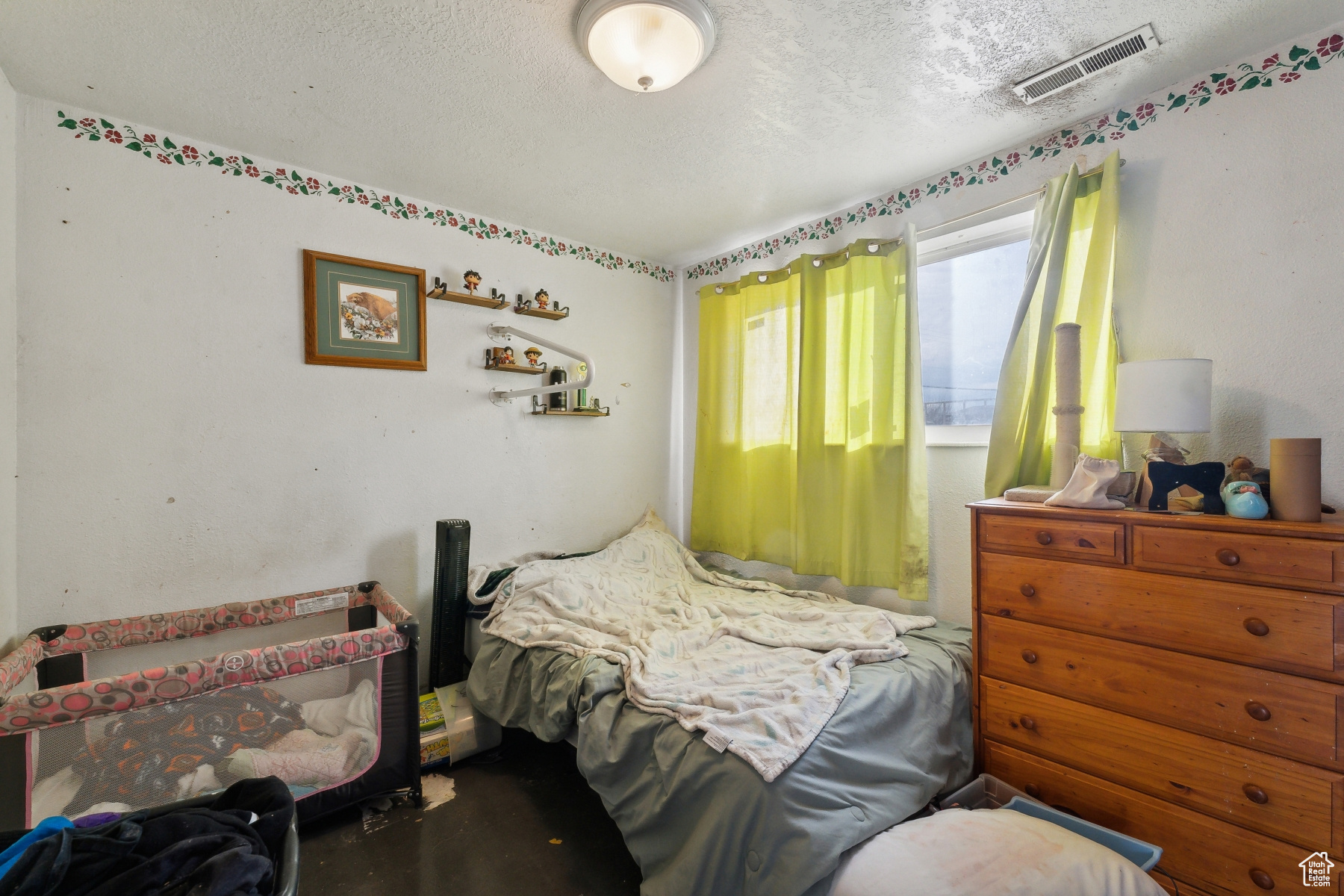 Bedroom with a textured ceiling