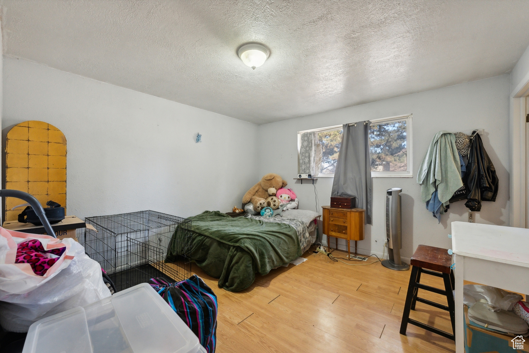 Bedroom featuring a textured ceiling and hardwood / wood-style flooring