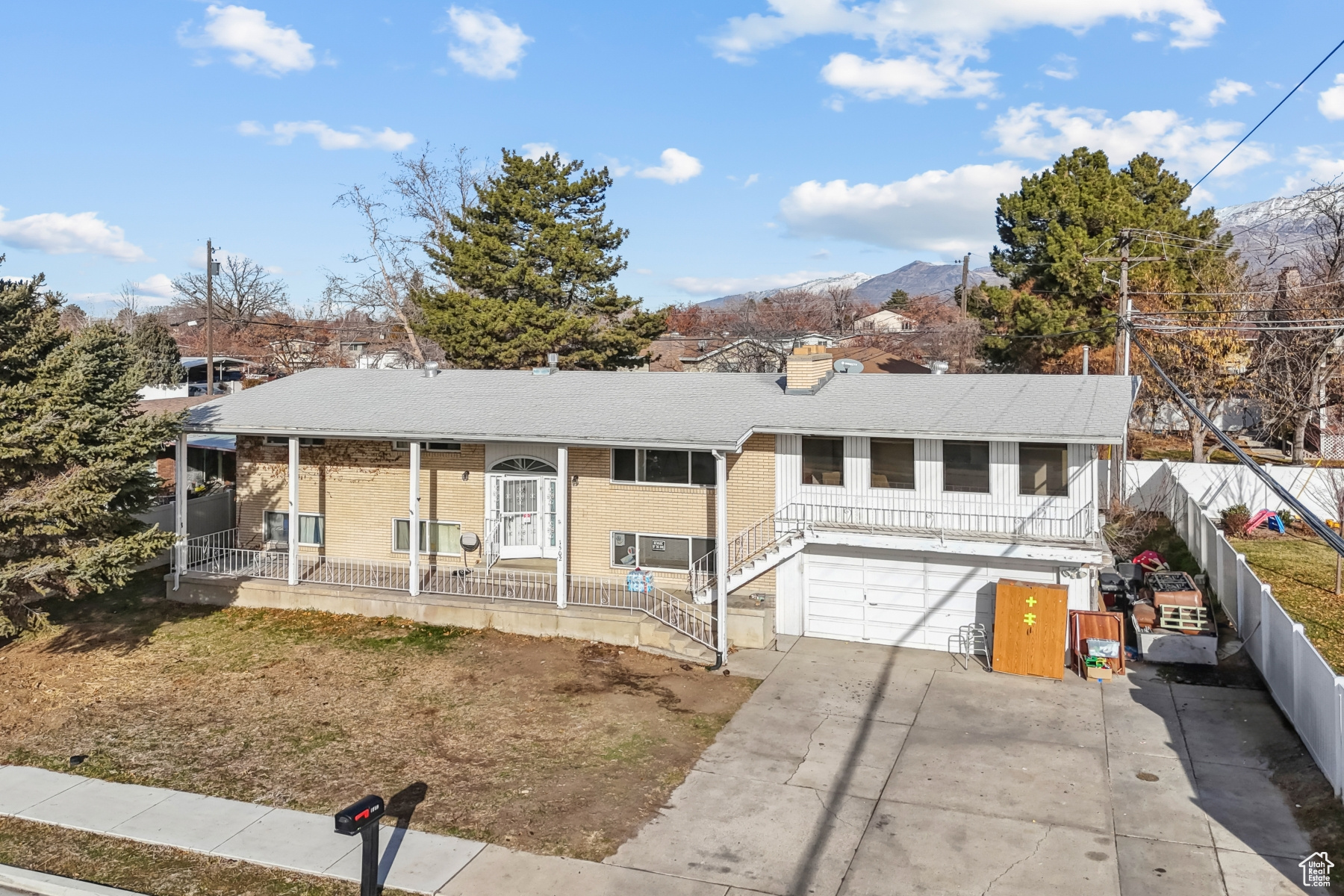 View of front facade with a mountain view, a porch, and a garage