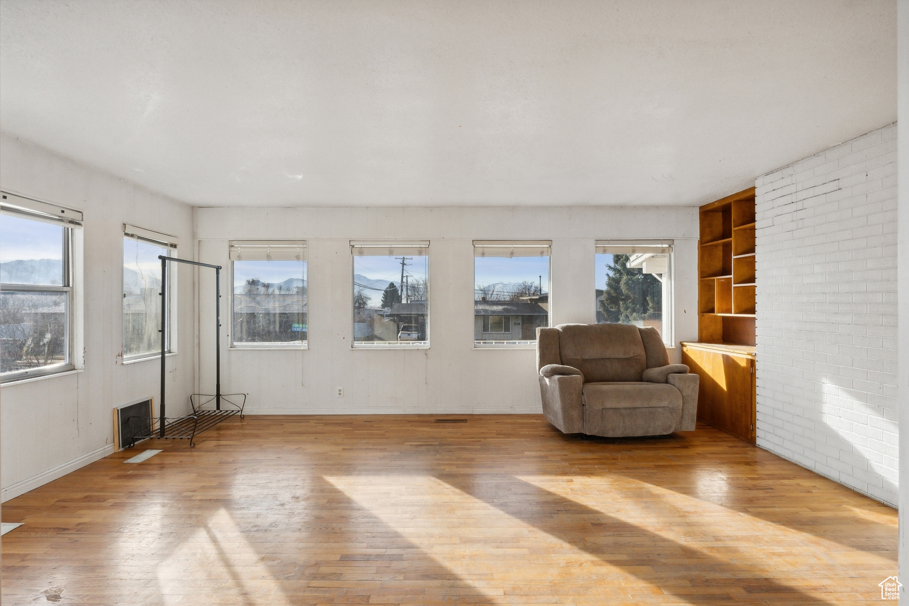 Unfurnished room featuring plenty of natural light and light hardwood / wood-style flooring