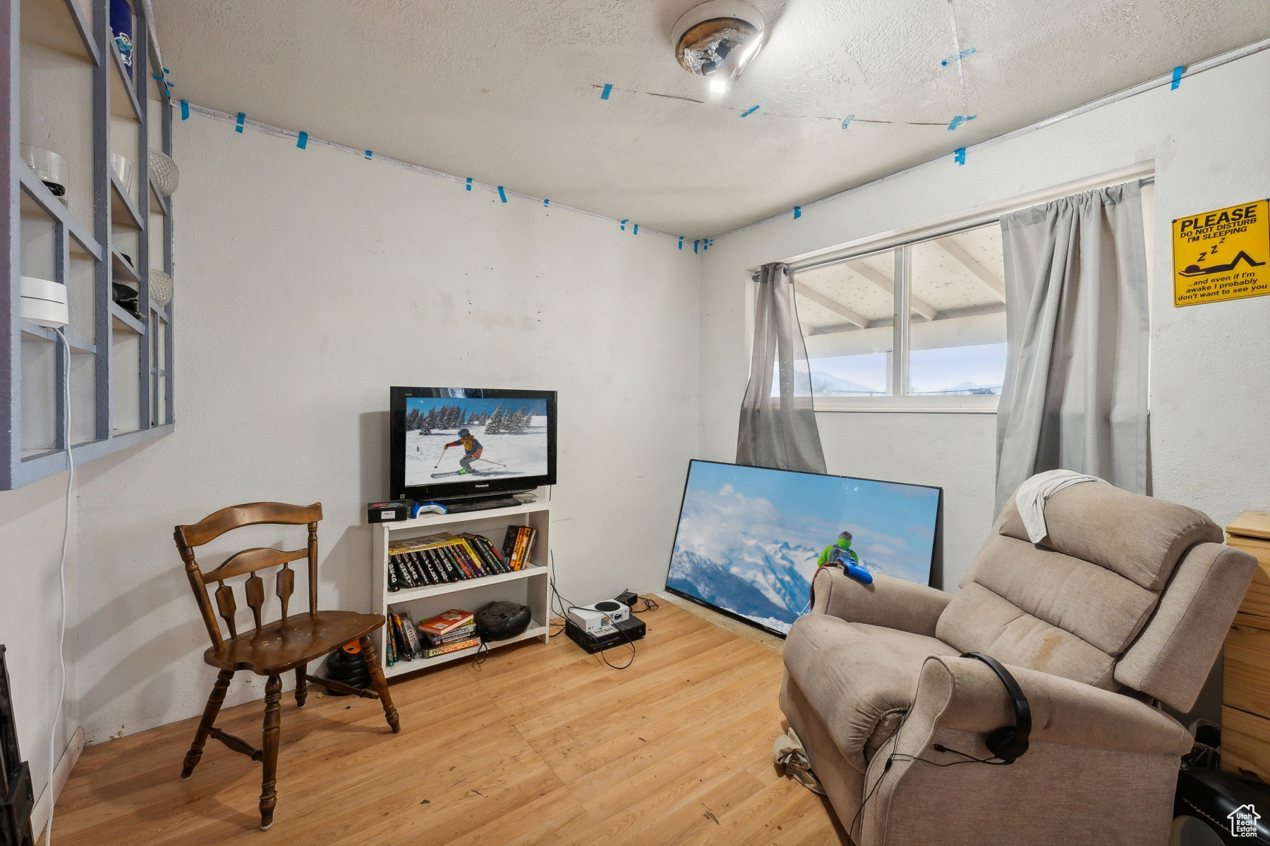 Living area with hardwood / wood-style floors and a textured ceiling