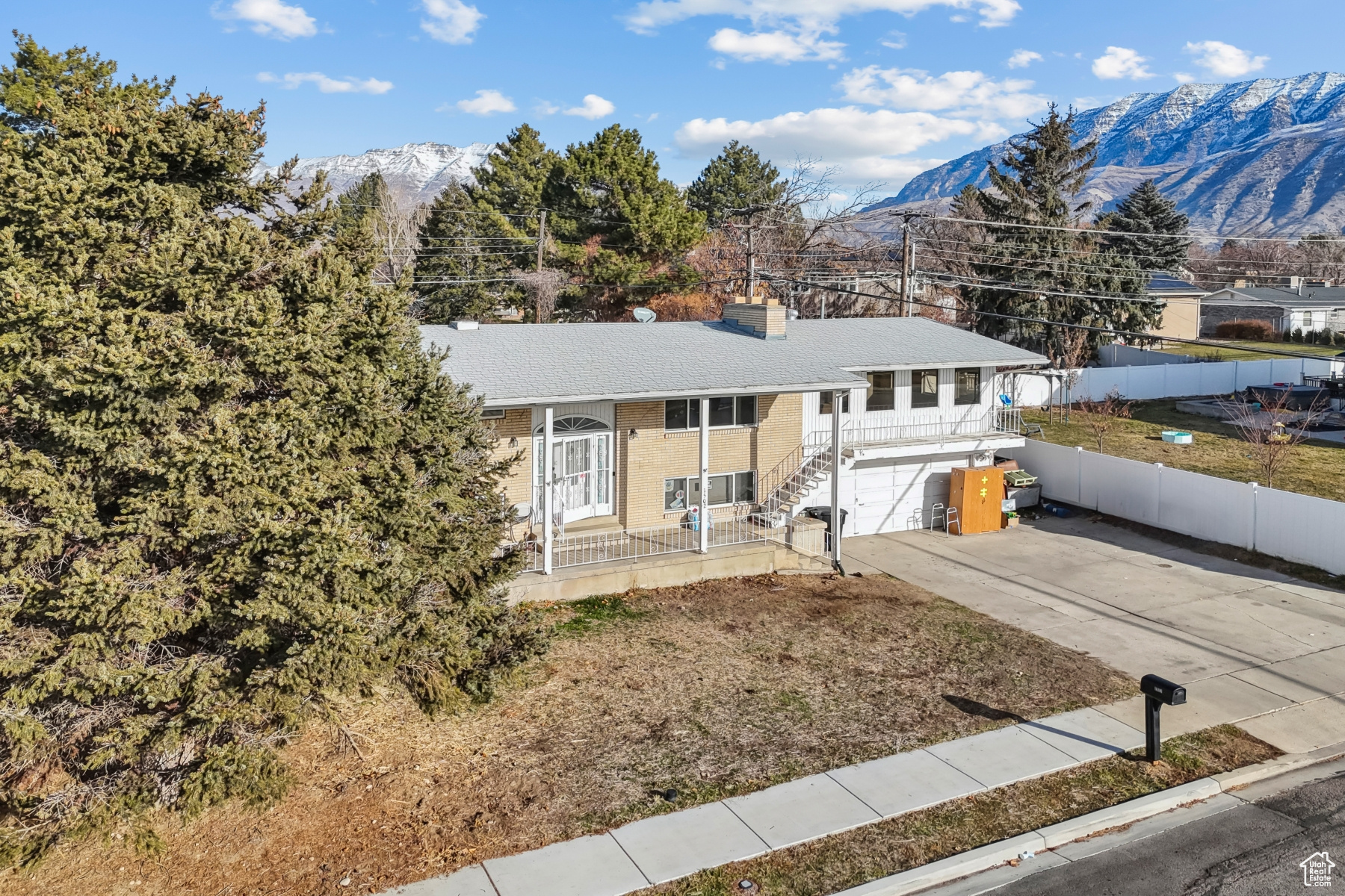 View of front of property with a mountain view and a garage