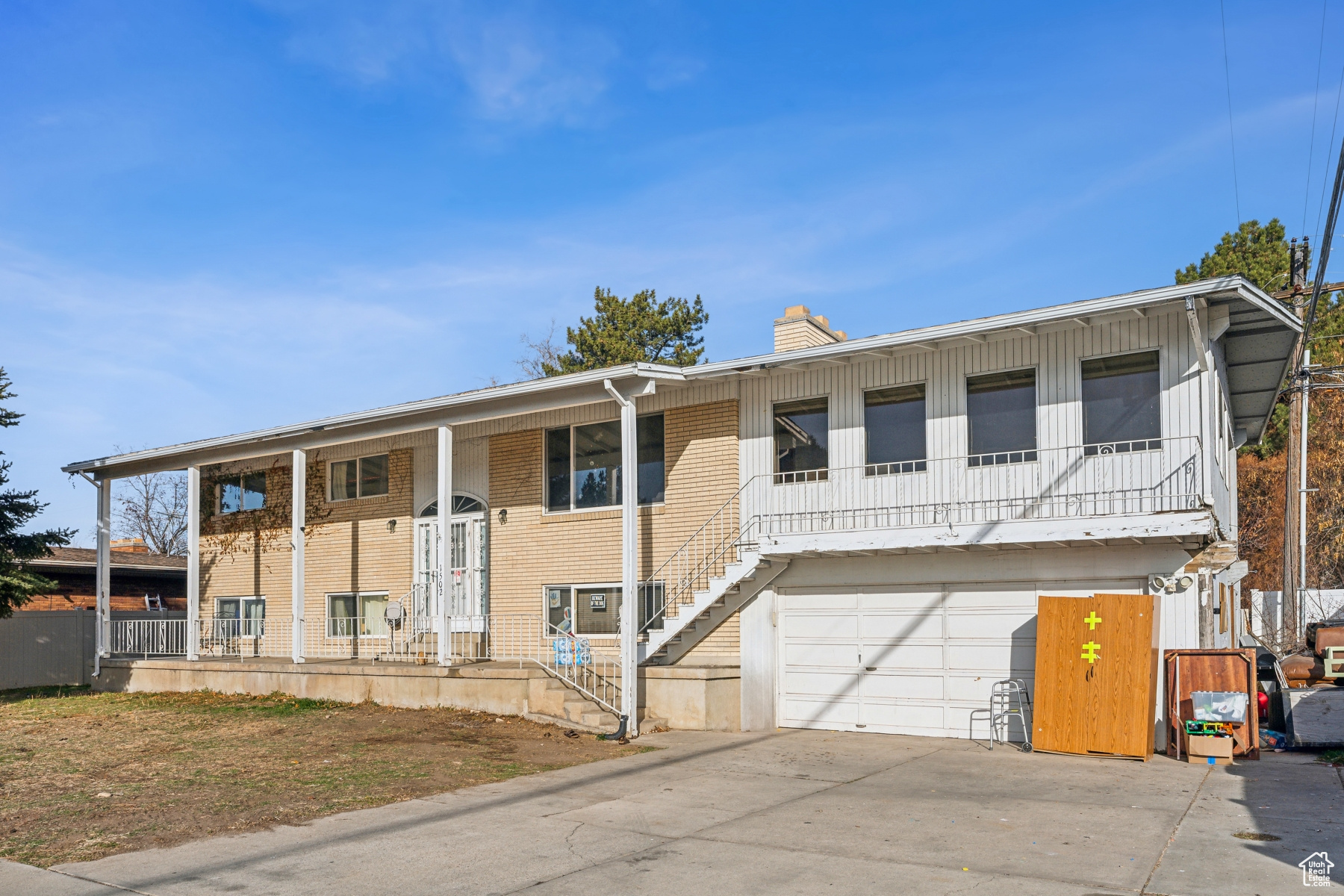 View of front facade with a porch and a garage